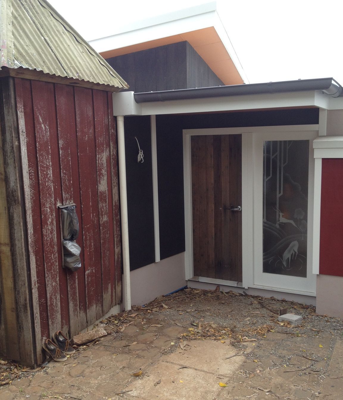 Entry door from The Fishermans Association Hut, salvage art deco 'mountain deer' motif acid etched doors as sidelights (protective 3m film to flat side for safety), original duck shed, now guest wc, was removed during construction and re-erected on new slab .