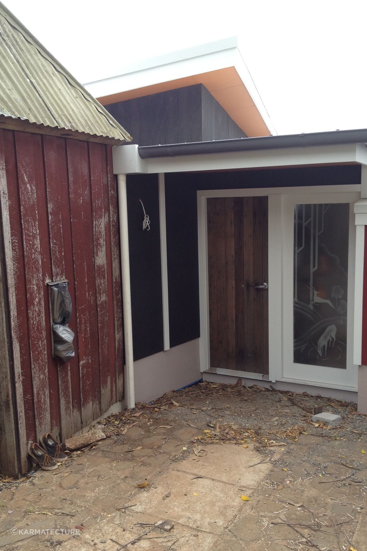 Entry door from The Fishermans Association Hut, salvage art deco 'mountain deer' motif acid etched doors as sidelights (protective 3m film to flat side for safety), original duck shed, now guest wc, was removed during construction and re-erected on new slab .