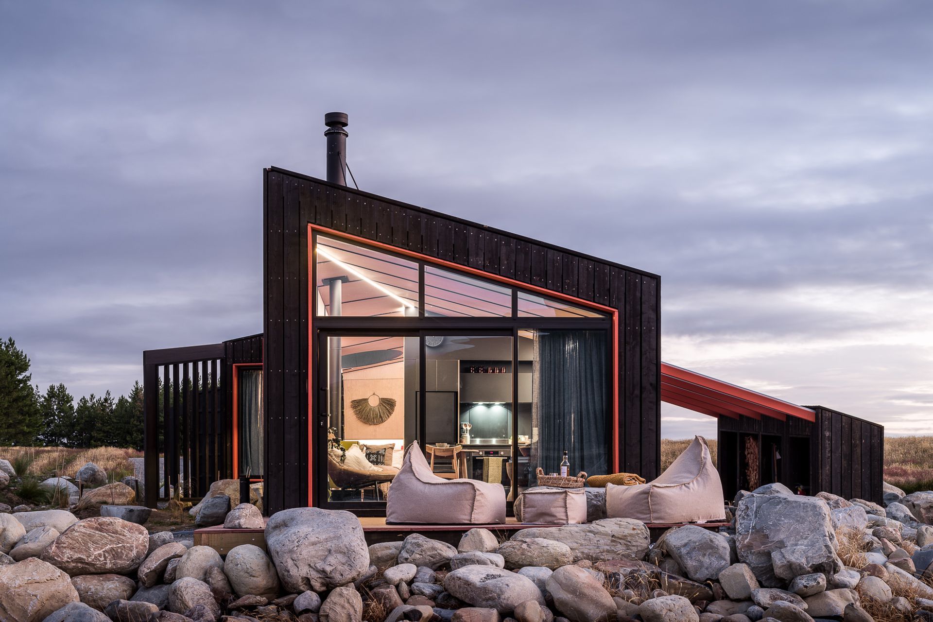 A deck, built over and around the rock plinth, provides an all-important outdoor space from which to revel in the peaceful surroundings.