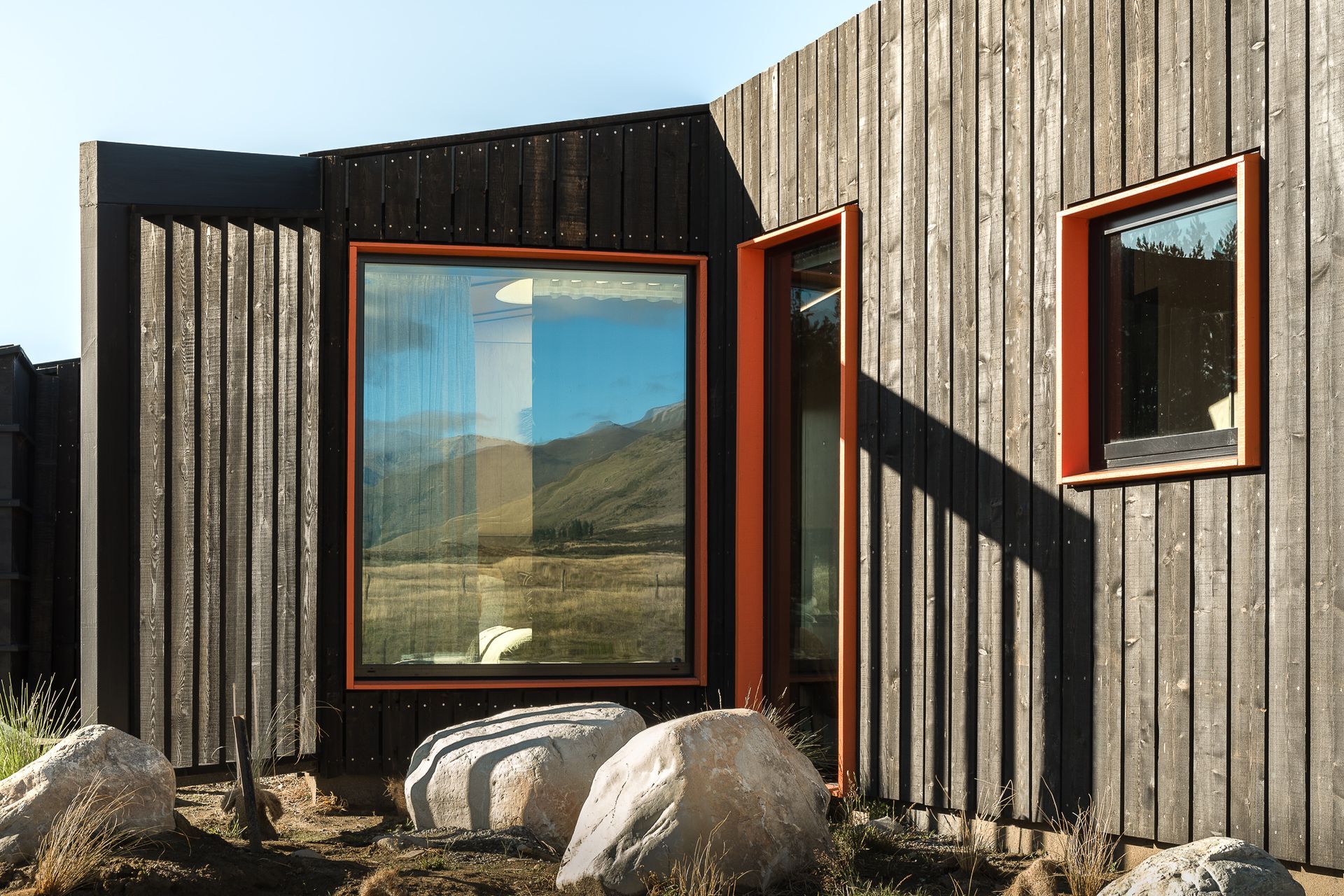 The seemingly random placement of the windows actually accommodates purposefully framed views of the mountains and surroundings that throughout the day and night provide interest, perspective and scale.