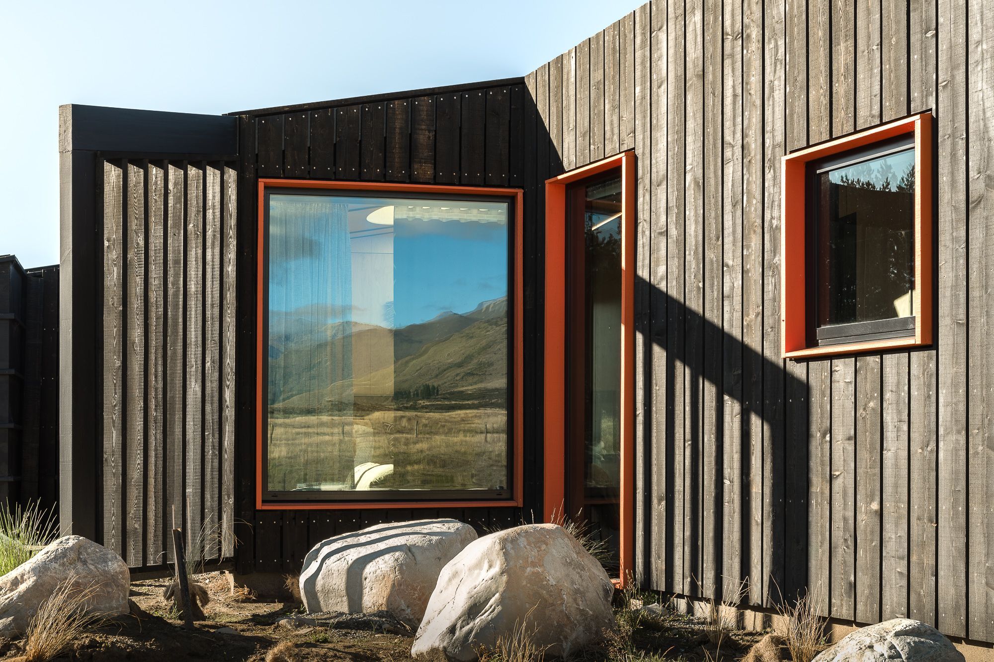The seemingly random placement of the windows actually accommodates purposefully framed views of the mountains and surroundings that throughout the day and night provide interest, perspective and scale.
