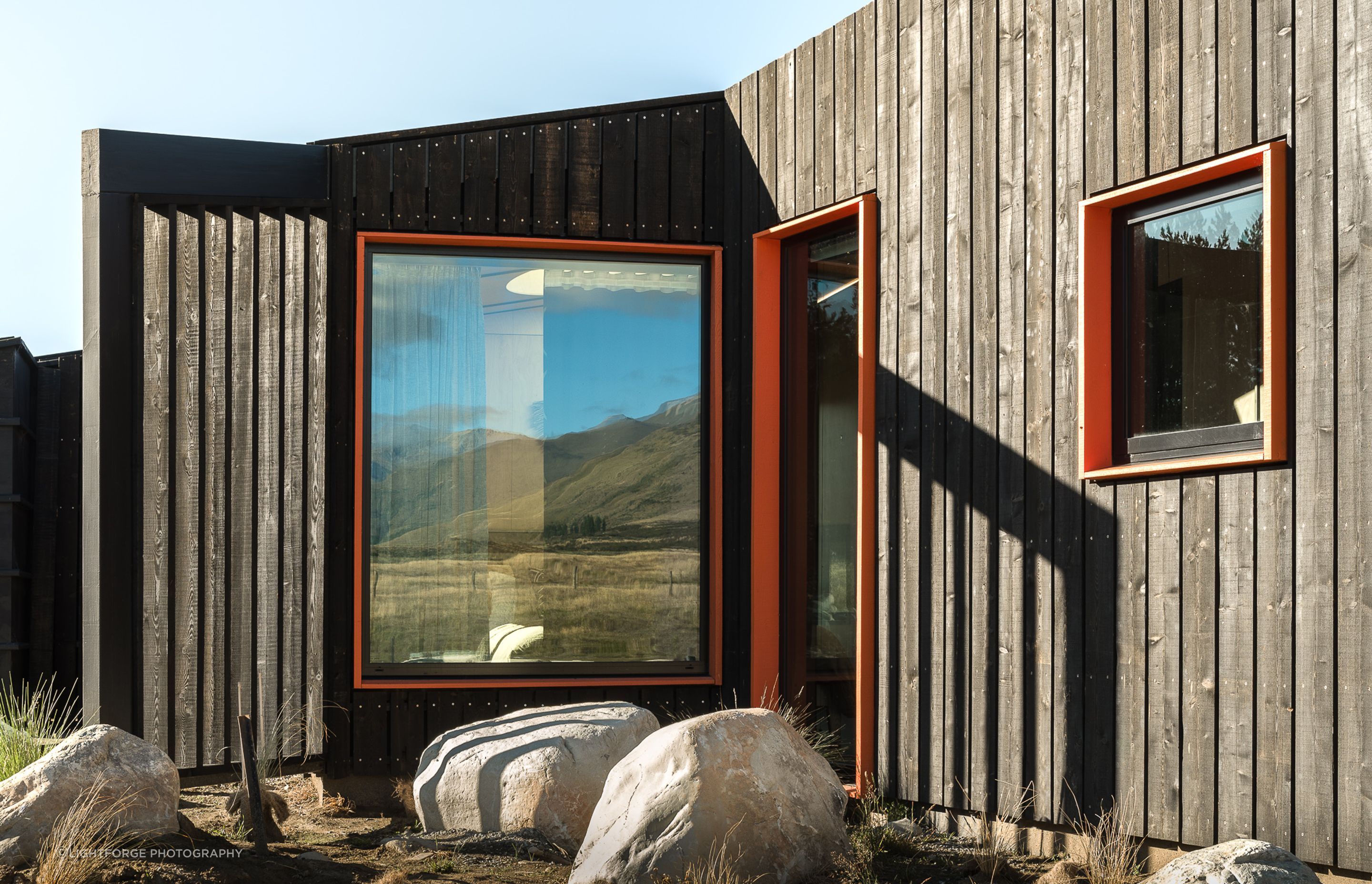The seemingly random placement of the windows actually accommodates purposefully framed views of the mountains and surroundings that throughout the day and night provide interest, perspective and scale.