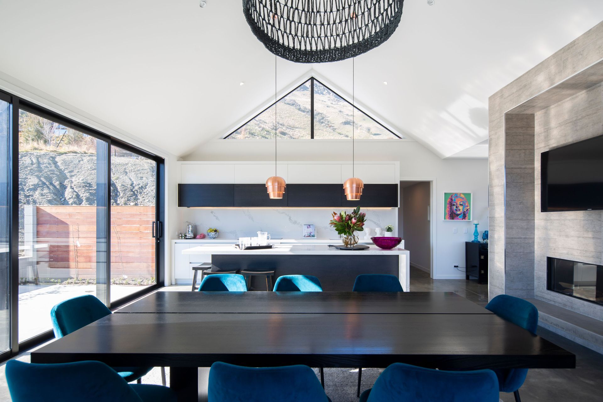 The apex above the kitchen rises to 5.4 metres and has clerestory windows to admit the view. Copper Pine Cone pendants are from BoConcept.