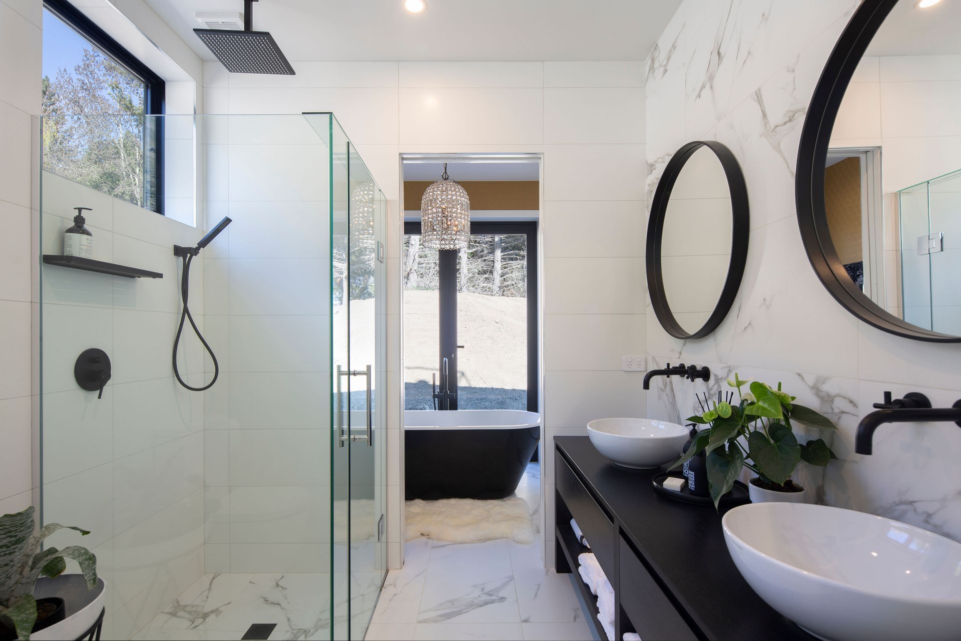 Main bathroom which follows a contemporary black and white theme with same marble floor tiling as the guest bathroom from Flooring Xtra.