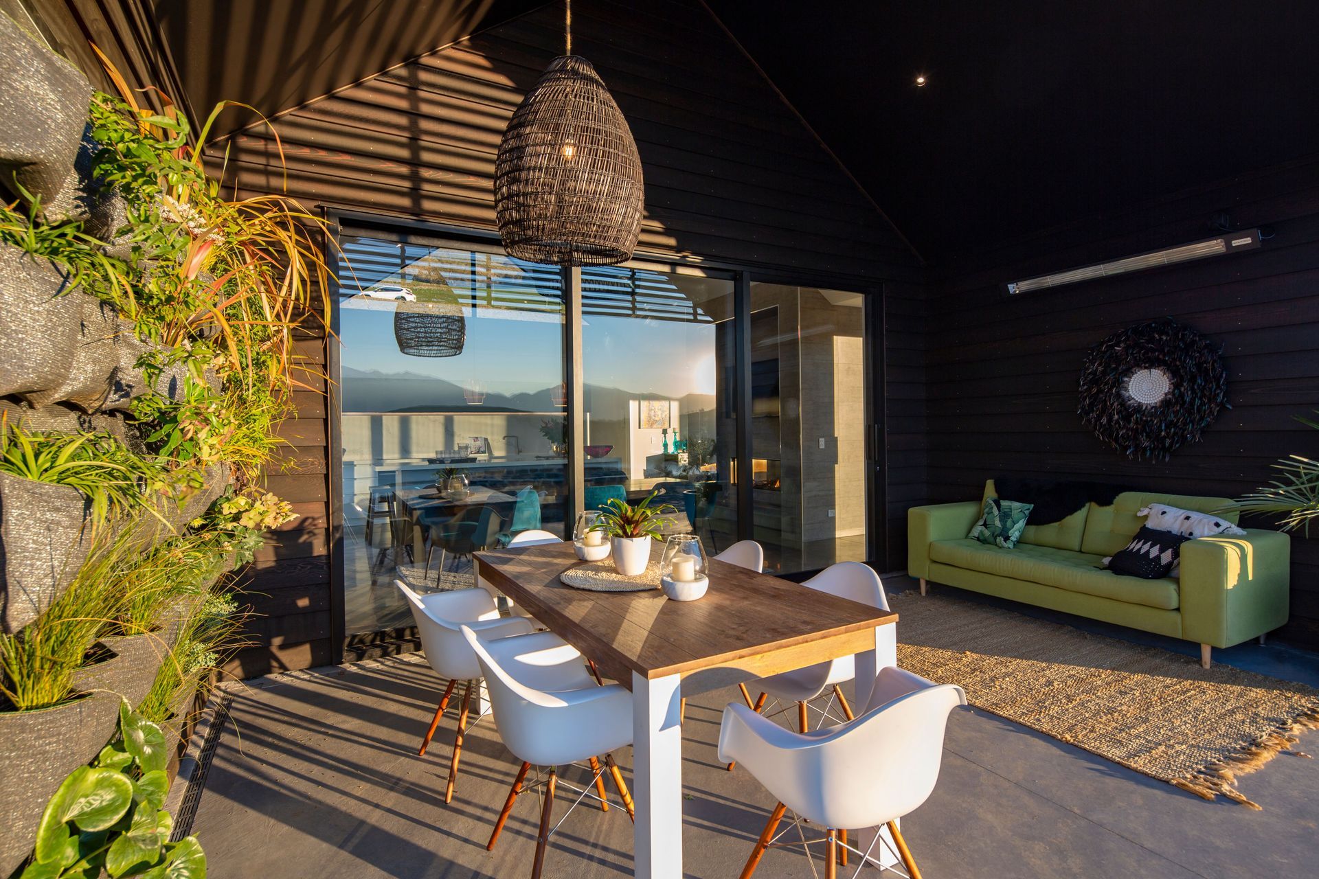 Pendant bought from Queenstown interiors is a focal point above the outdoor dining table in the lakefront courtyard