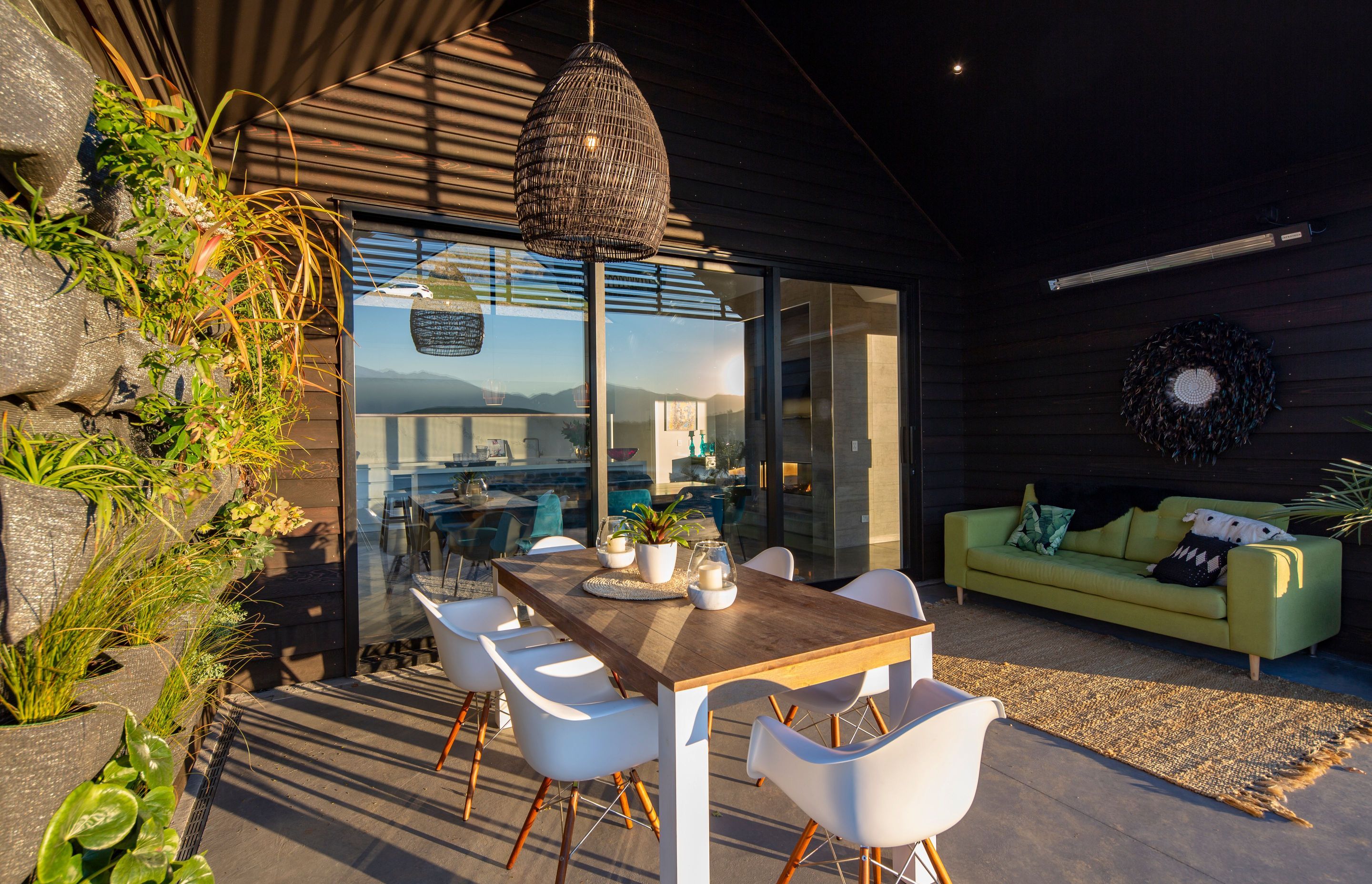Pendant bought from Queenstown interiors is a focal point above the outdoor dining table in the lakefront courtyard