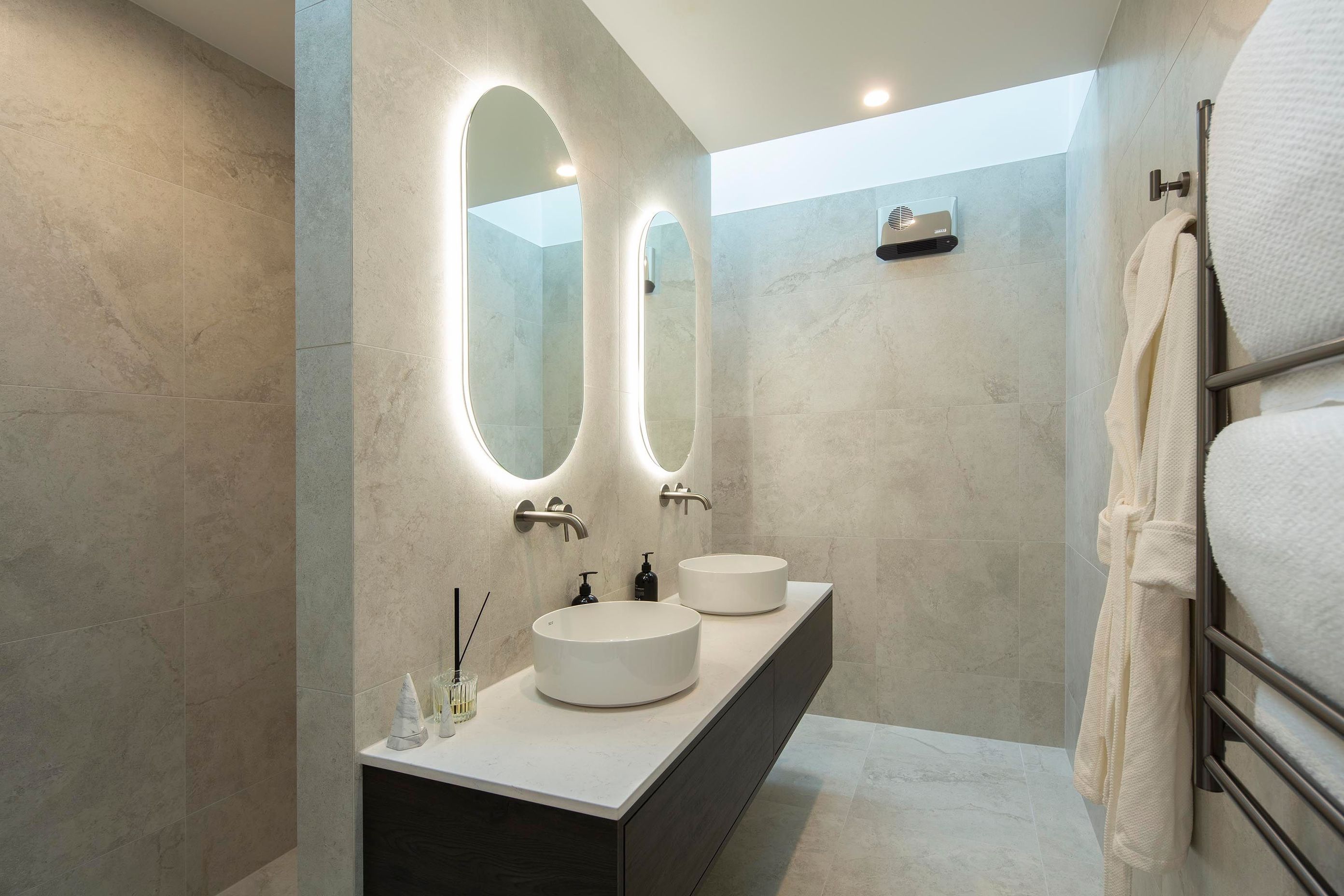 Modern-ensuite-with-twin-vanities-and-oval-mirrors.jpg