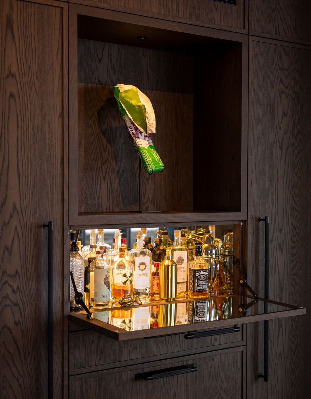 A mini-bar concealed in the kitchen cabinetry. The homeowners are art collectors - the K Bar sculpture is by Simon Lewis Wards.