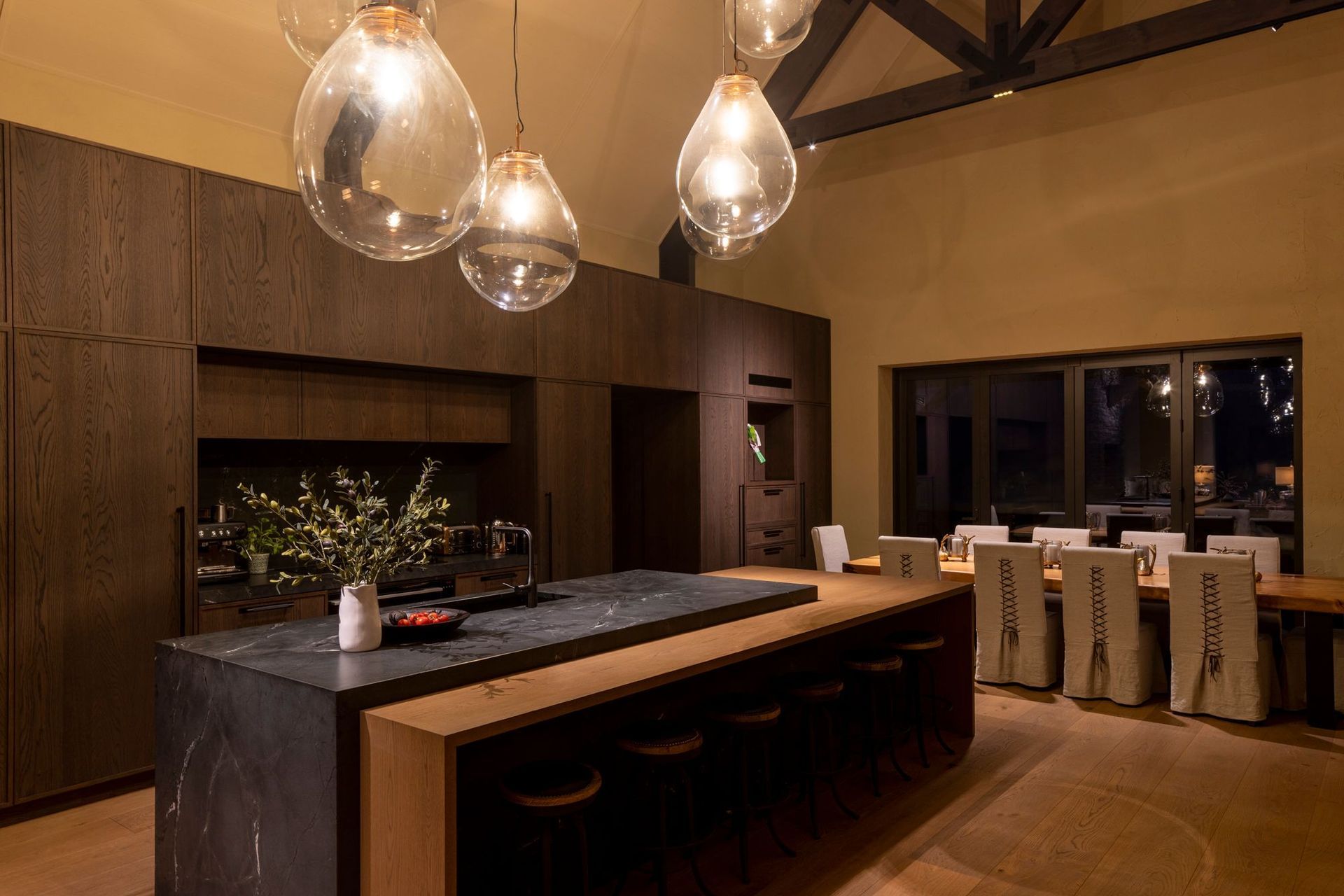 “The dining table is a swamp kauri slab from Dargaville, which was found early on and then a base was constructed for it. The dining chairs were custom made with leather detailing on the back,” says Vee.