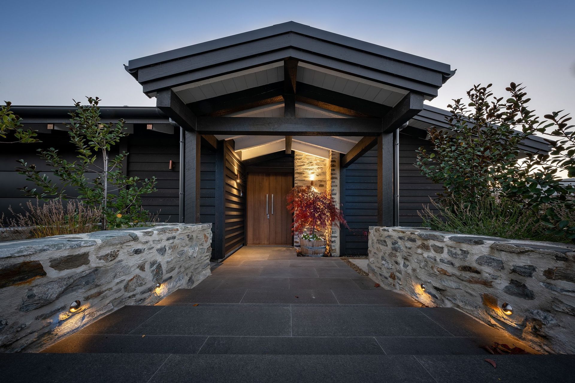 Dramatic in its colour scheme and bold materials, the solidity of the front of this home belies its almost total openness beyond the front door.