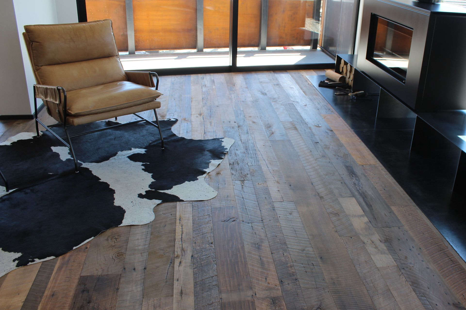 corten steel, black metal and leather complement the recycled timber floor