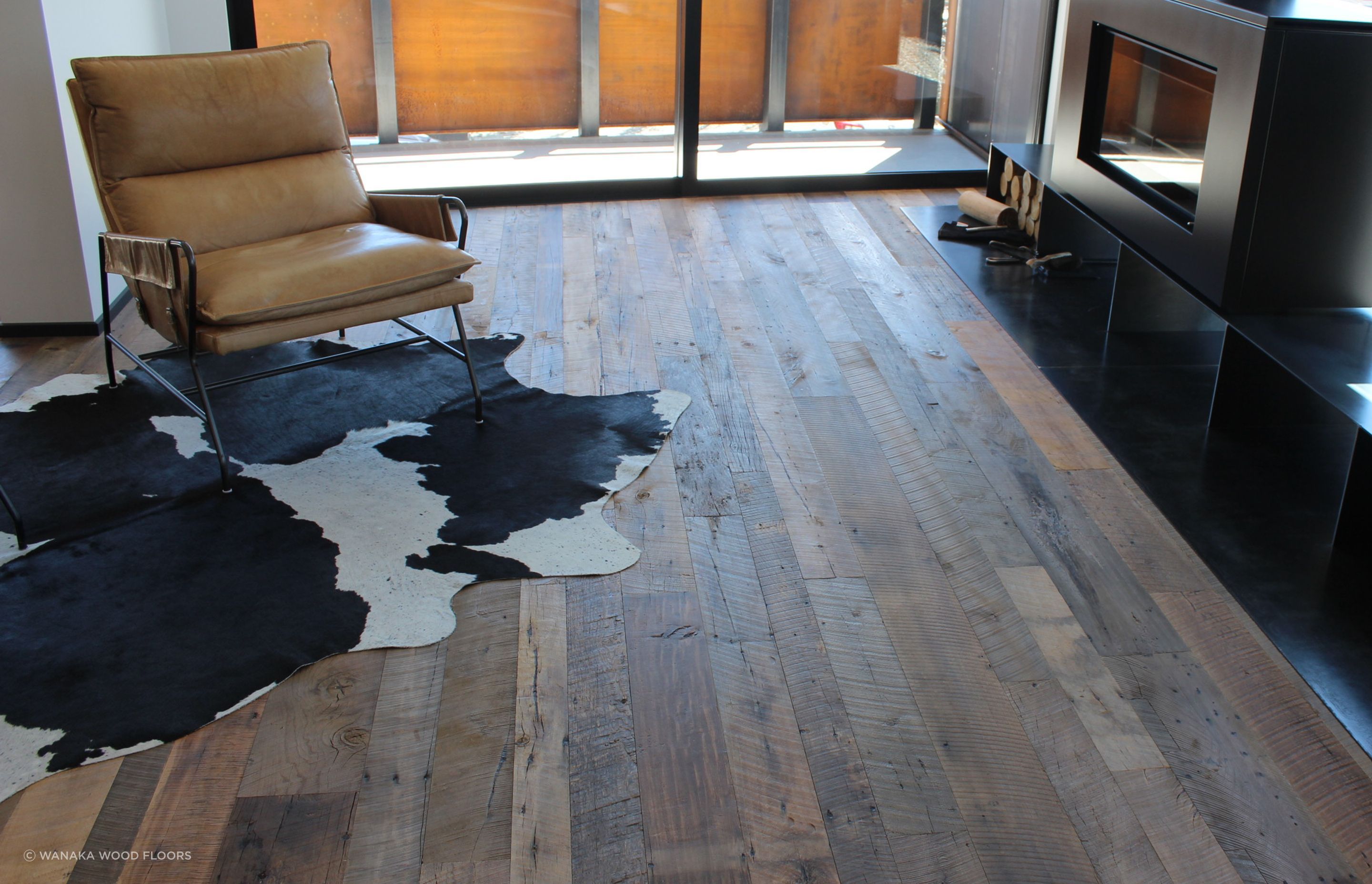 corten steel, black metal and leather complement the recycled timber floor