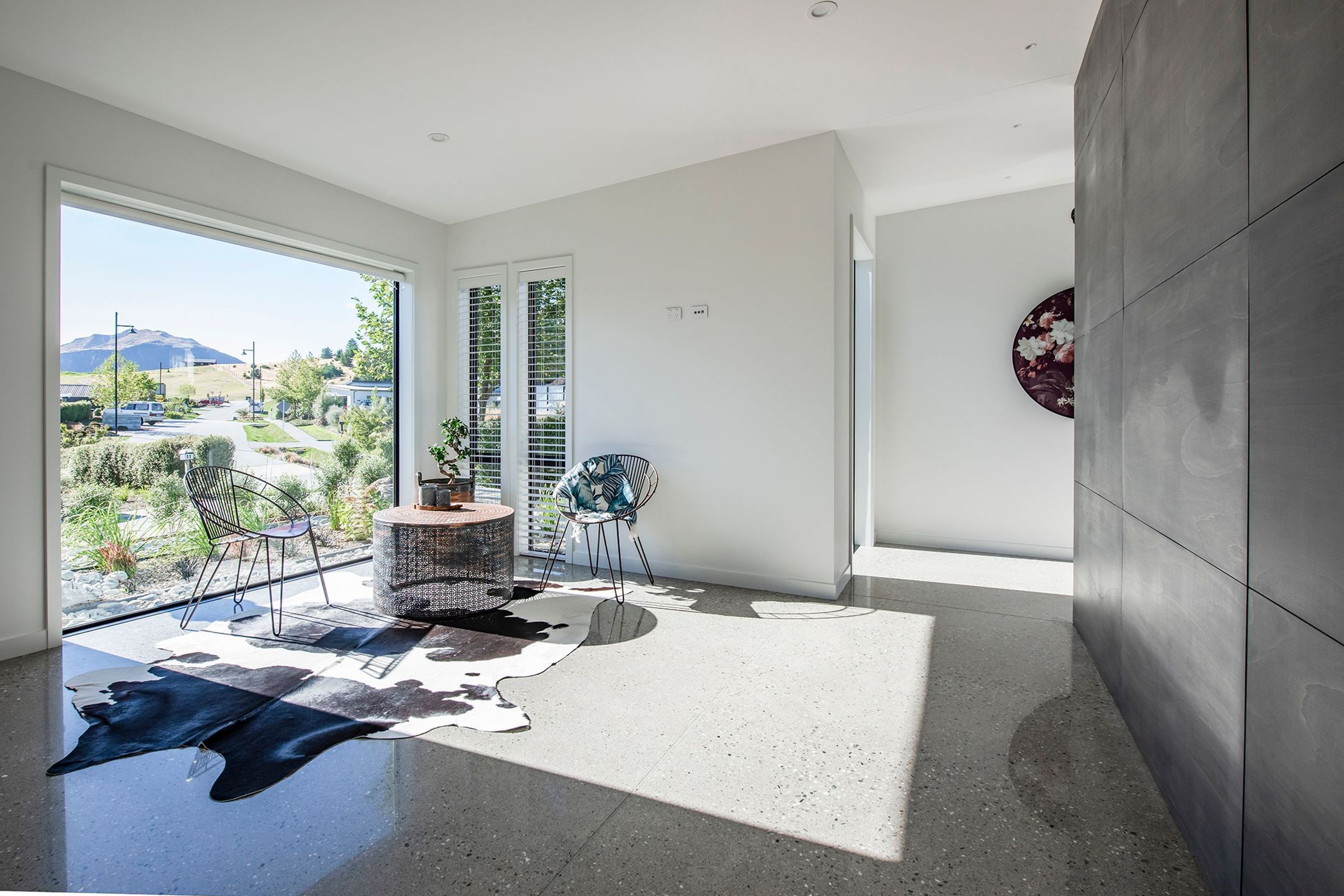 Glossy polished floors reflect the furnishings and foliage in this sunny coffee area