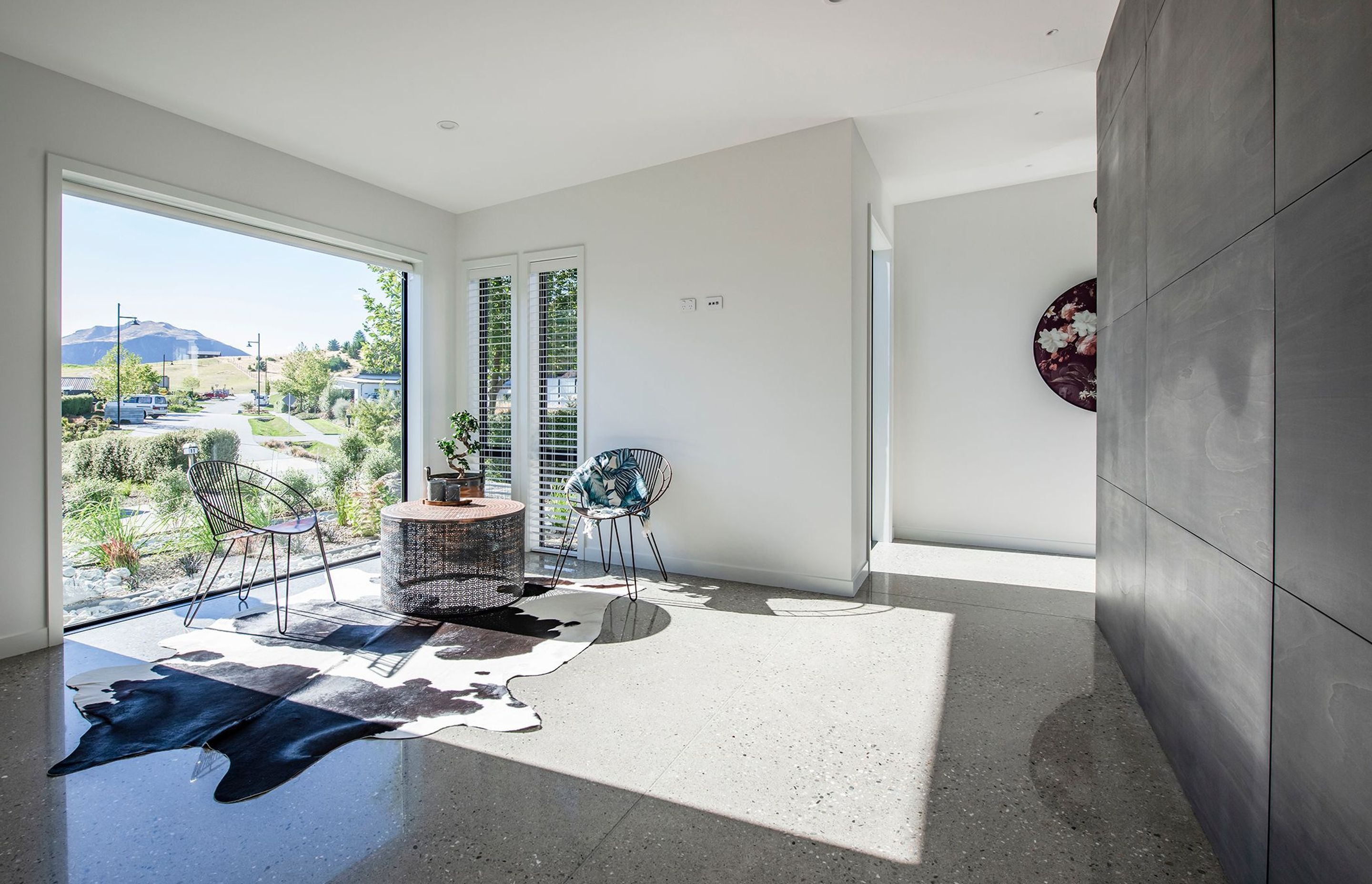 Glossy polished floors reflect the furnishings and foliage in this sunny coffee area