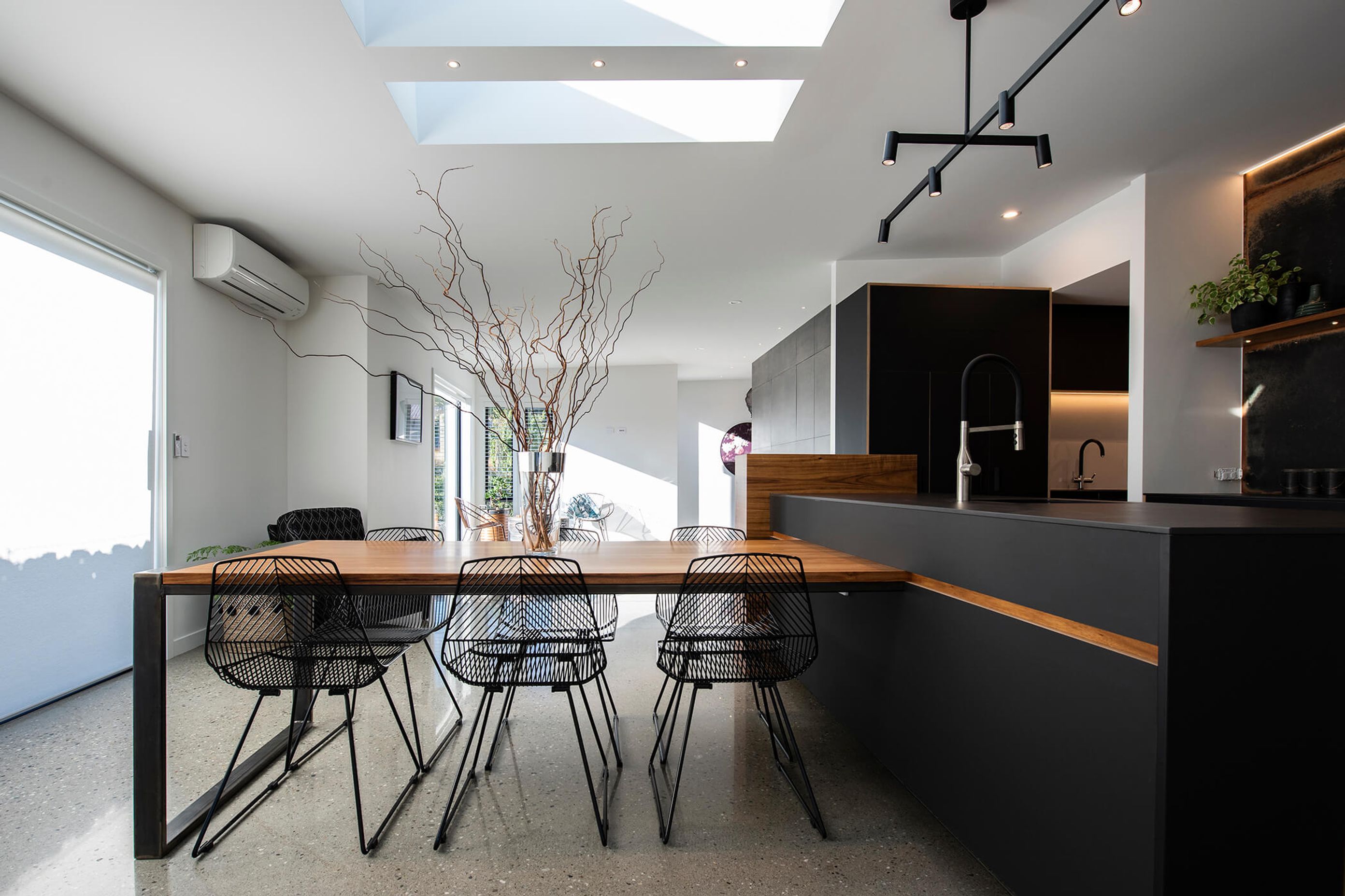 The table which is connected to island bench is topped with blackwood veneer, and is a good spot to gather when outdoor dining is off the agenda.
