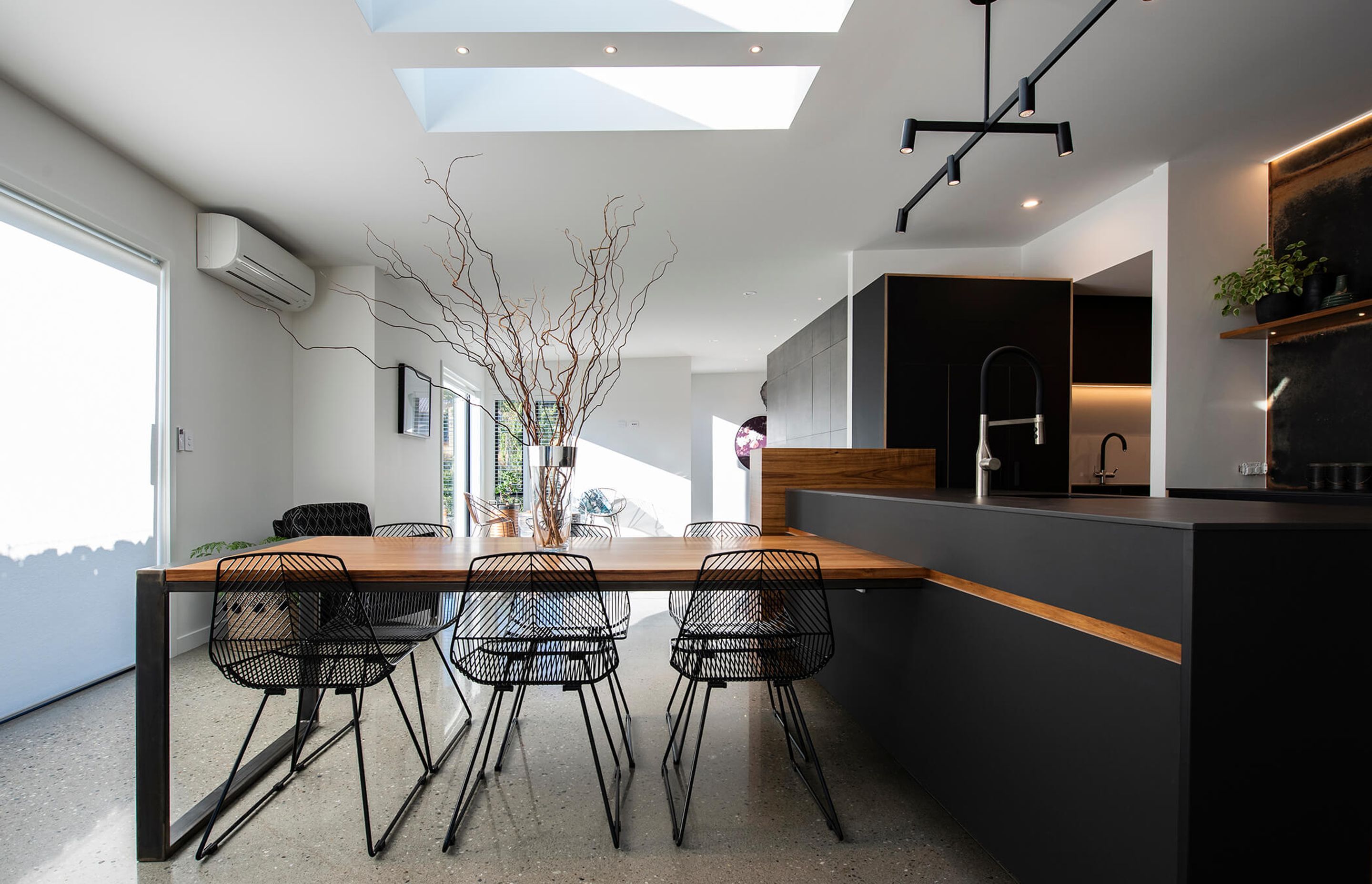 The table which is connected to island bench is topped with blackwood veneer, and is a good spot to gather when outdoor dining is off the agenda.