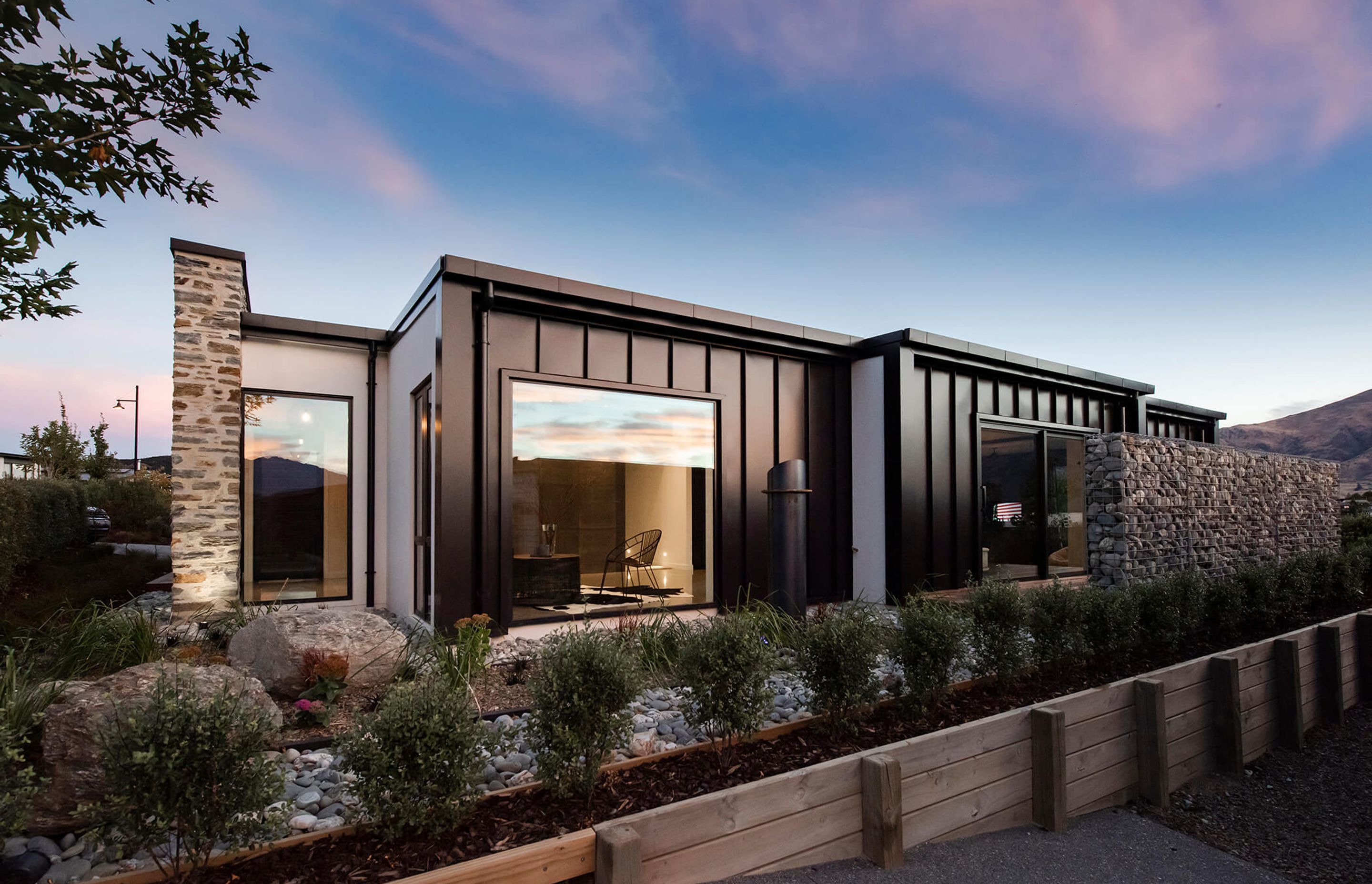 The schist wall anchors the home to the land and the landscape.