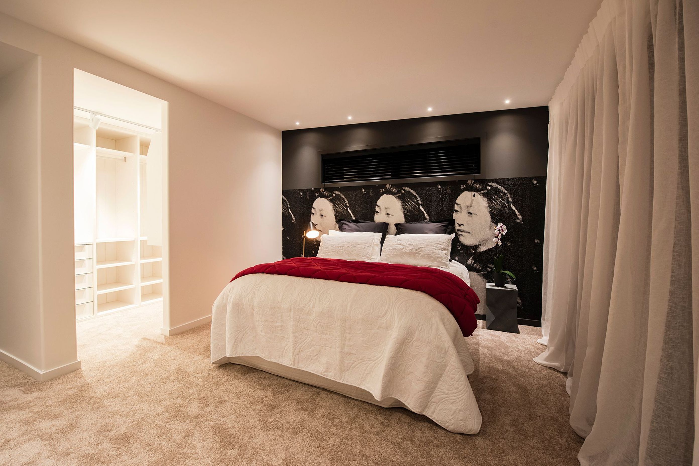 A mural of a Japanese lady is the unconventional backdrop to the bed in the main suite.