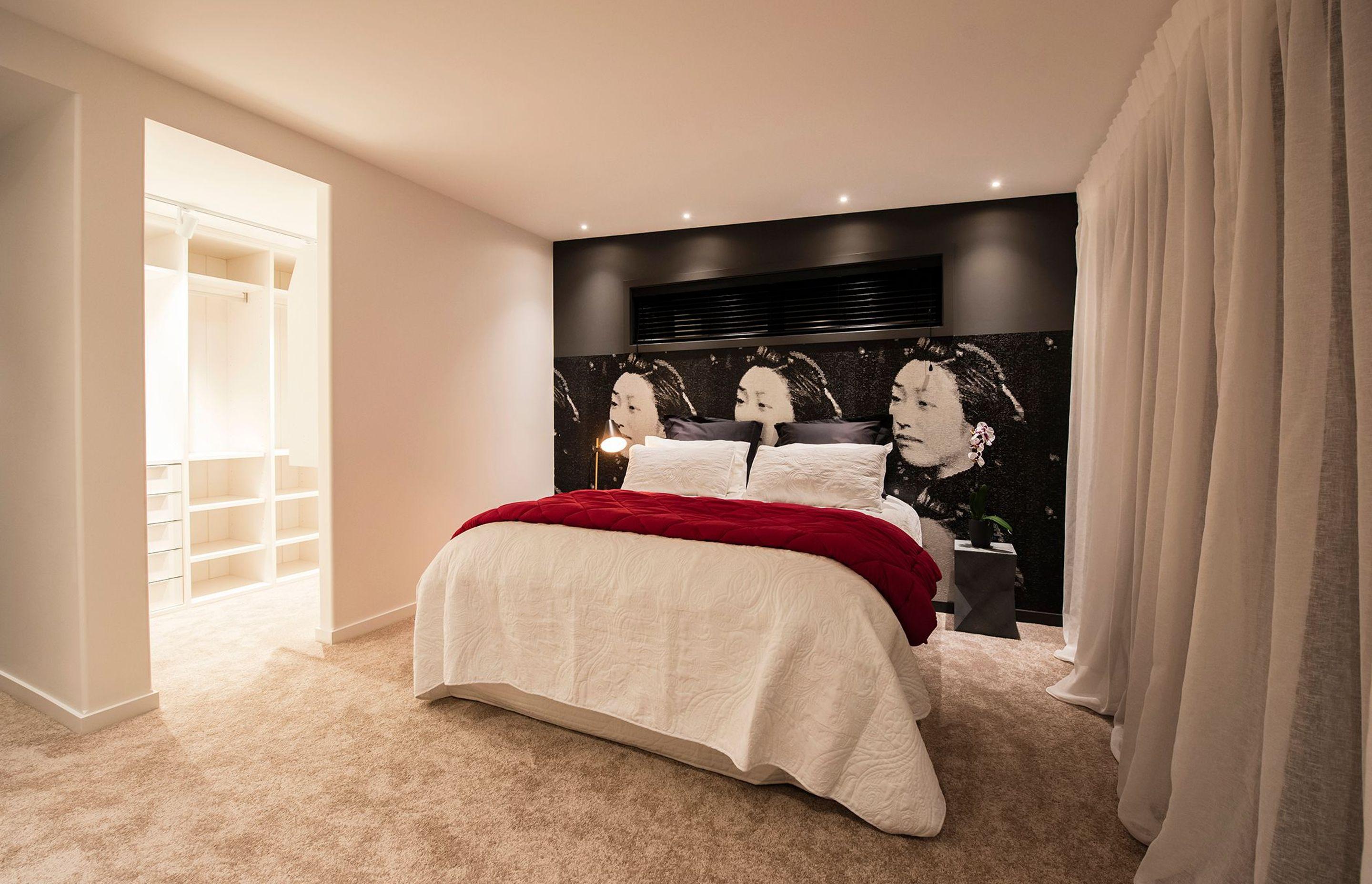 A mural of a Japanese lady is the unconventional backdrop to the bed in the main suite.