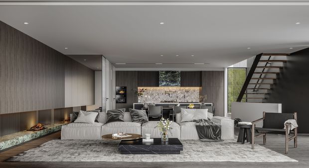 A sophisticated open-plan living room with a lounge area in the foreground and a compact kitchen or bar area behind it. The room features a low-profile white sectional sofa, neutral furnishings, a large pale patterned rug, dark stone or marble coffee table, full-height textured timber-look wall panelling, recessed ceiling lighting, and a dark feature wall. An open floating staircase with timber treads and a black structural frame rises at the right, while large windows bring in greenery.