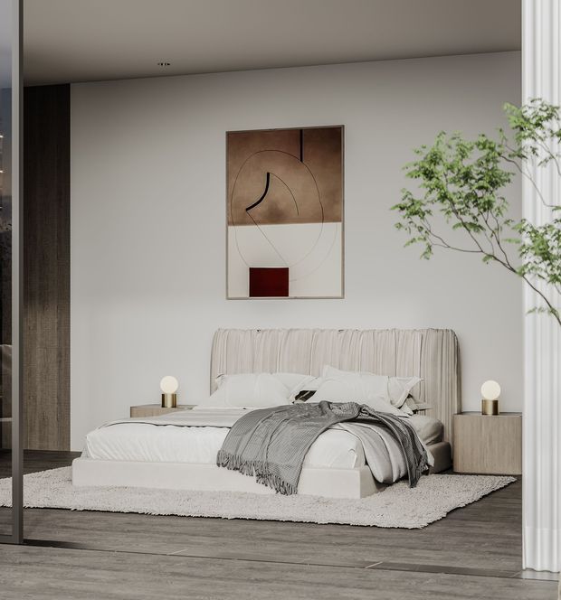 A serene contemporary bedroom with a low upholstered bed, softly pleated headboard, neutral bedding, matching bedside tables and spherical lamps. A restrained abstract artwork hangs above the bed, with a sculptural indoor tree beside full-height curtains. The room uses warm neutral tones, dark timber flooring, and minimalist built-in detailing.
