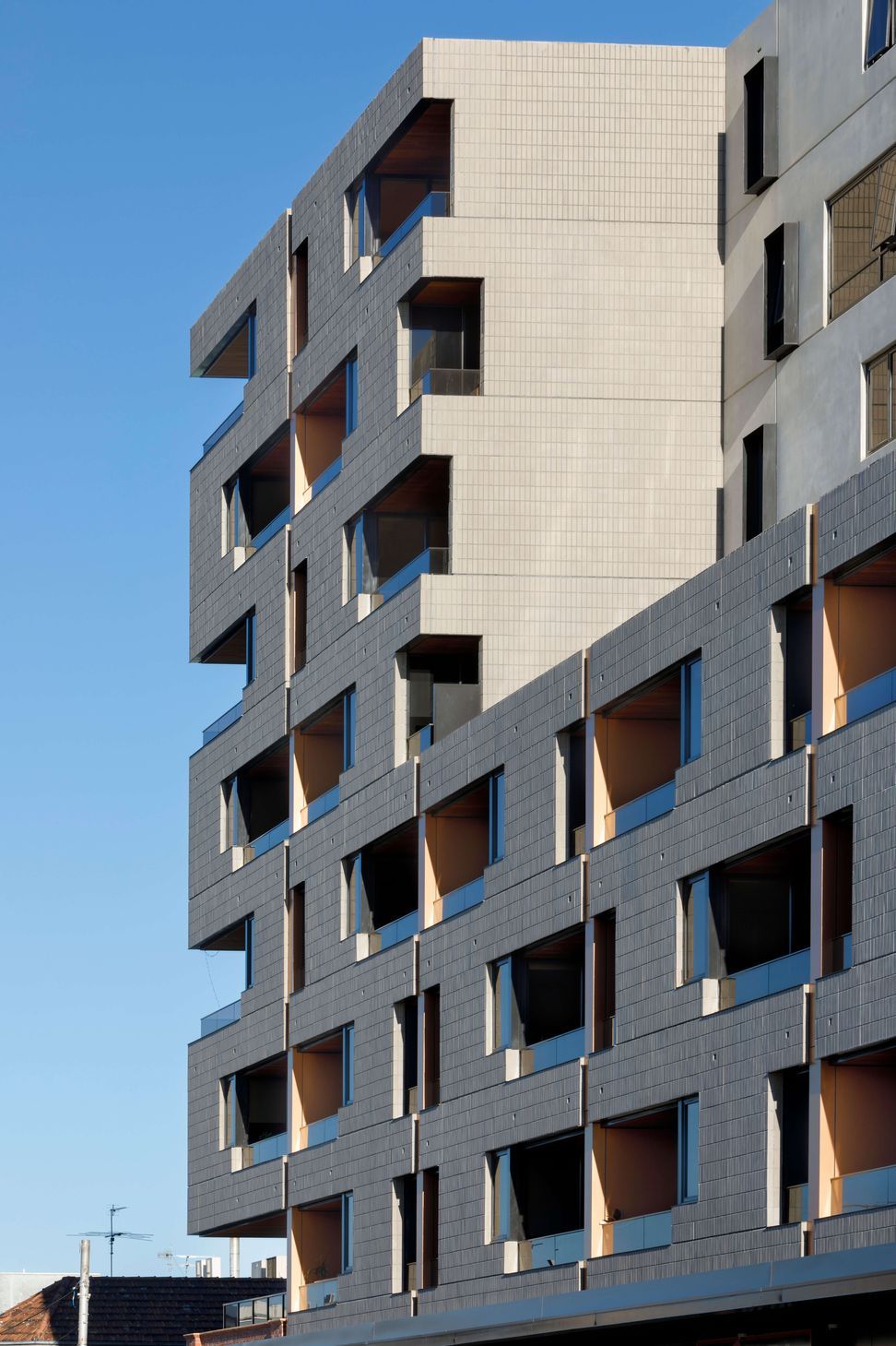 Ash Grey brick tiles are creatively articulated in the Brick Inlay facade