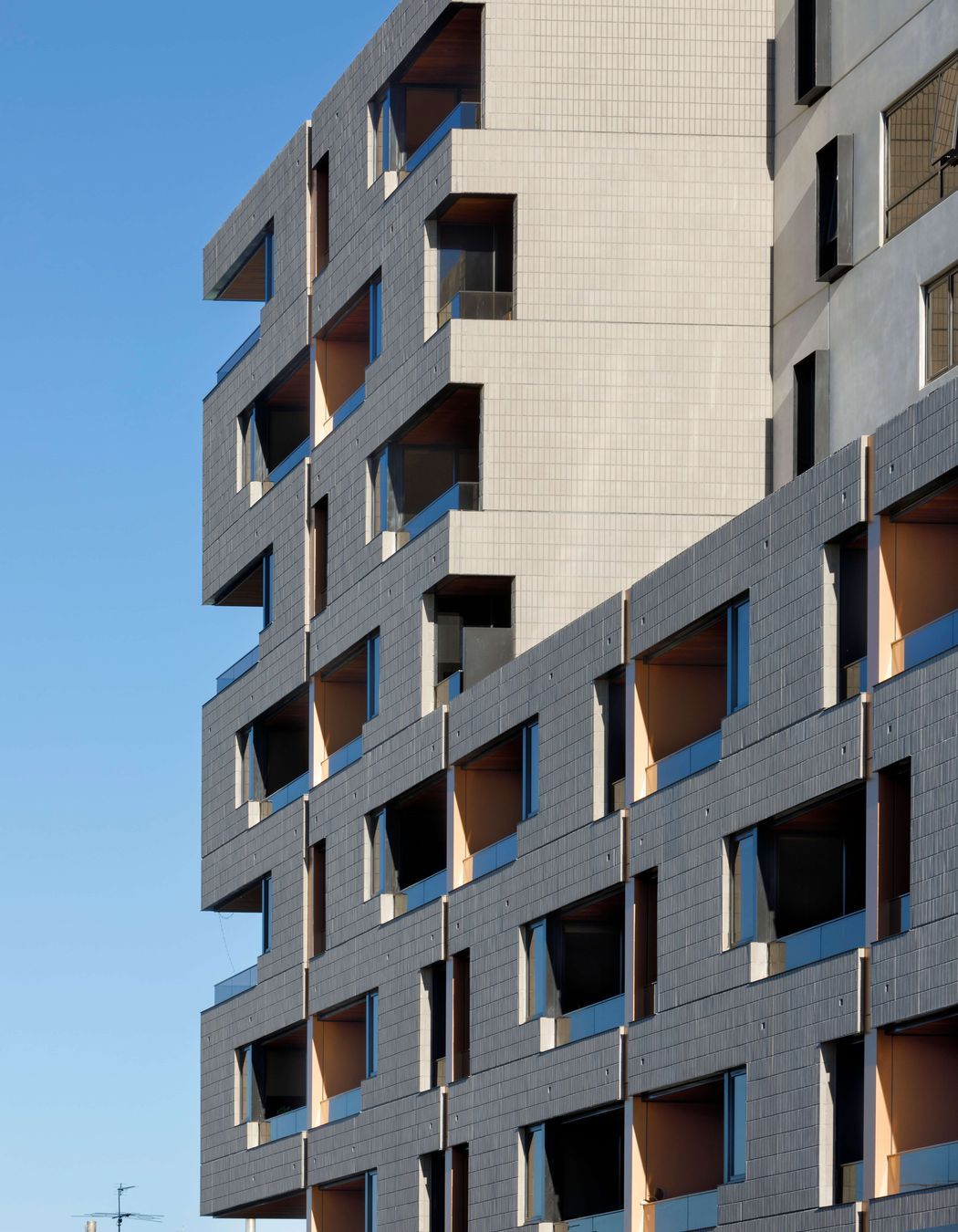 Ash Grey brick tiles are creatively articulated in the Brick Inlay facade