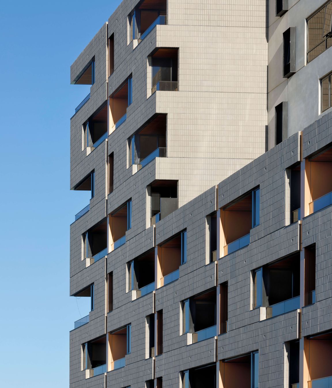 Ash Grey brick tiles are creatively articulated in the Brick Inlay facade