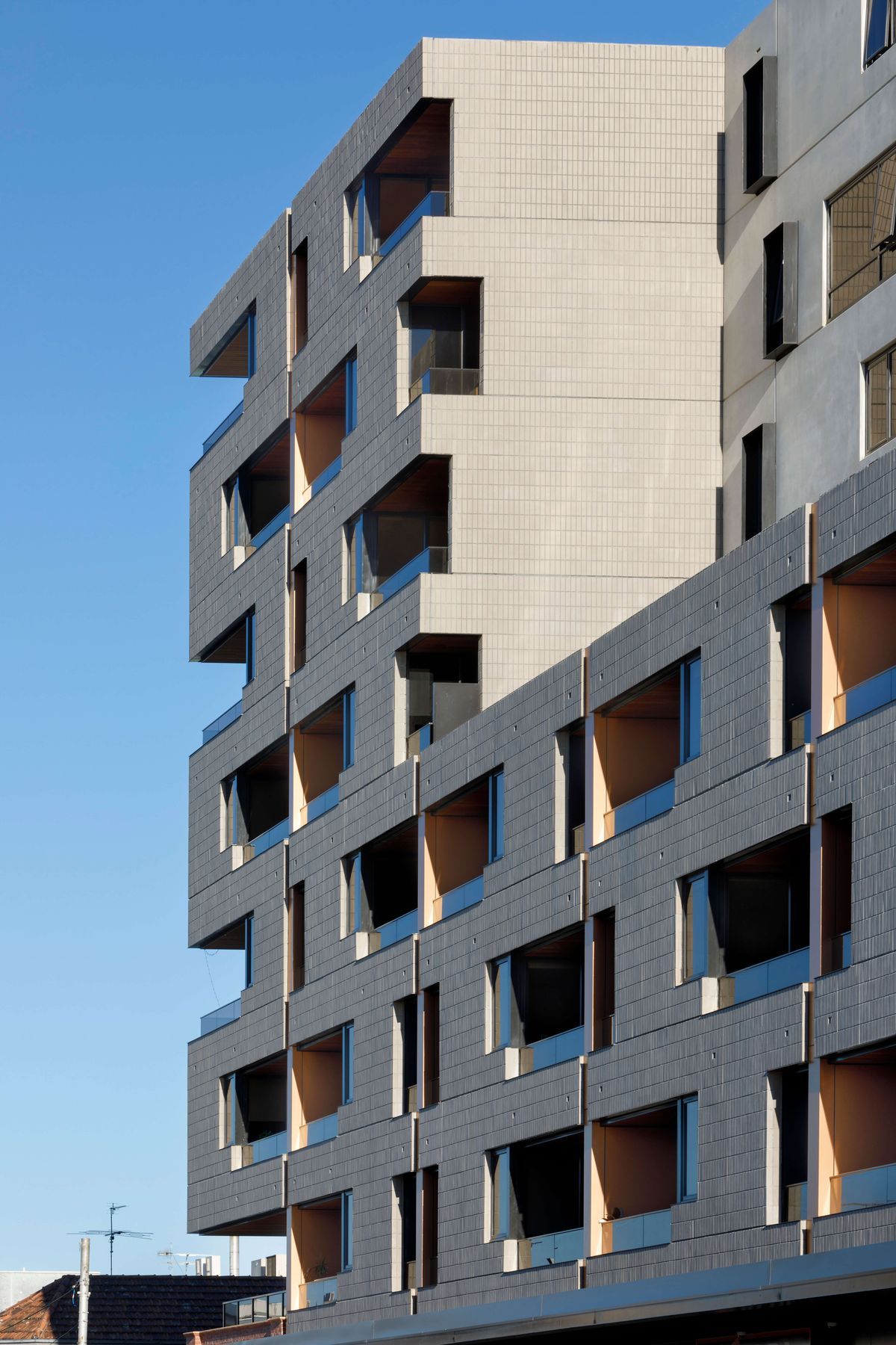 Ash Grey brick tiles are creatively articulated in the Brick Inlay facade