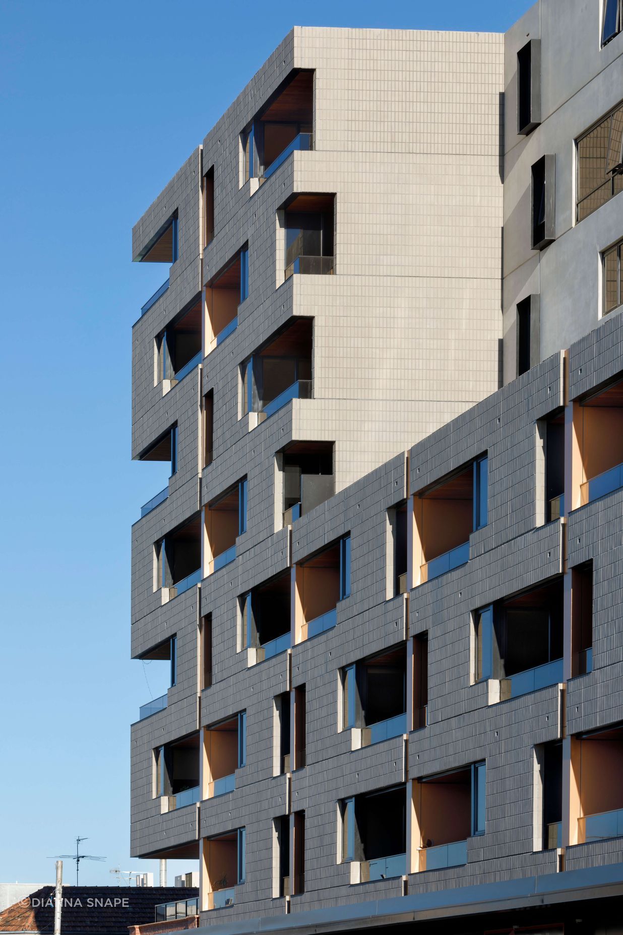 Ash Grey brick tiles are creatively articulated in the Brick Inlay facade