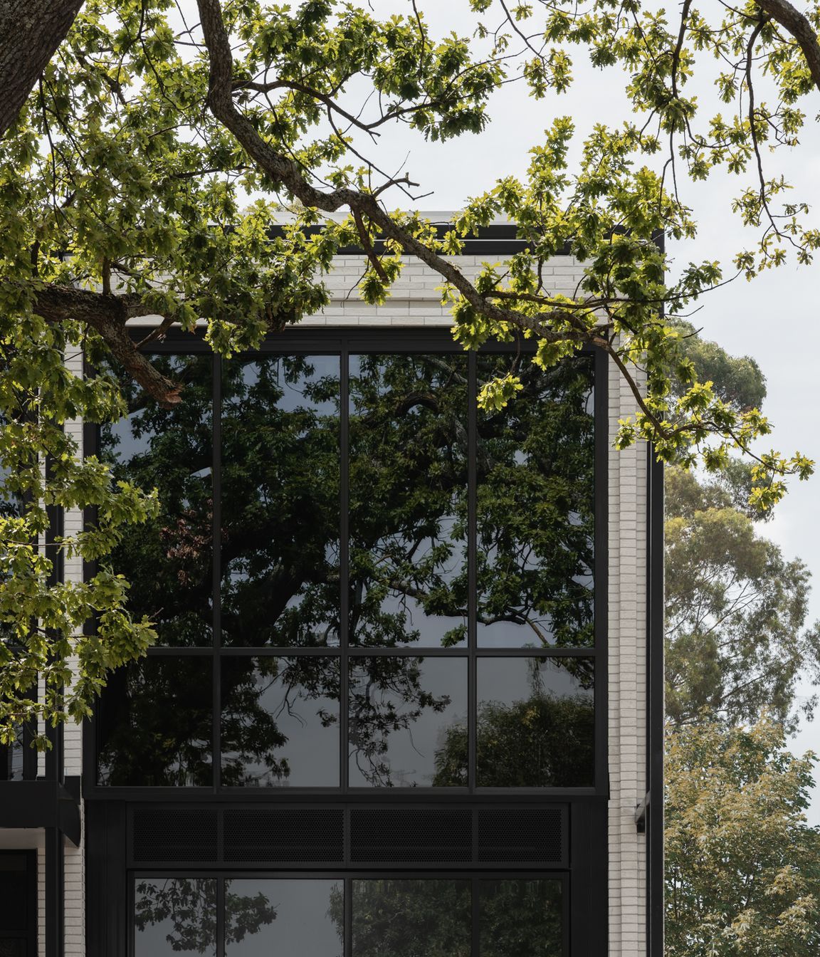 Brick Inlay delivers a finely tuned facade, featuring Mattoncino Grande Bianco brick tiles on the residential side