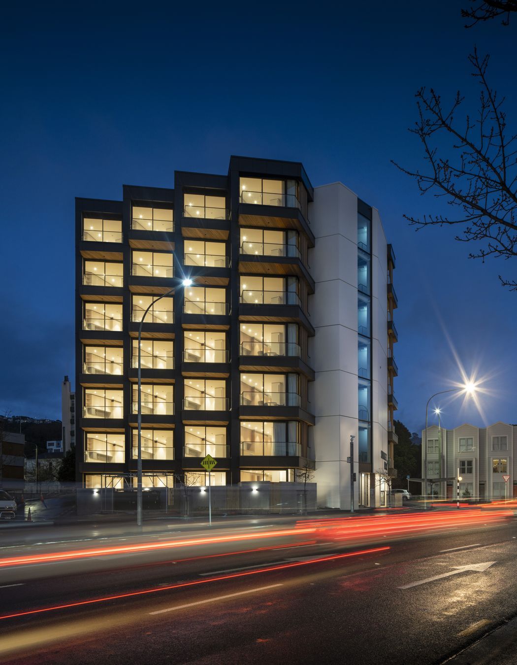 Each apartment features a balcony with views of the city and its maunga.