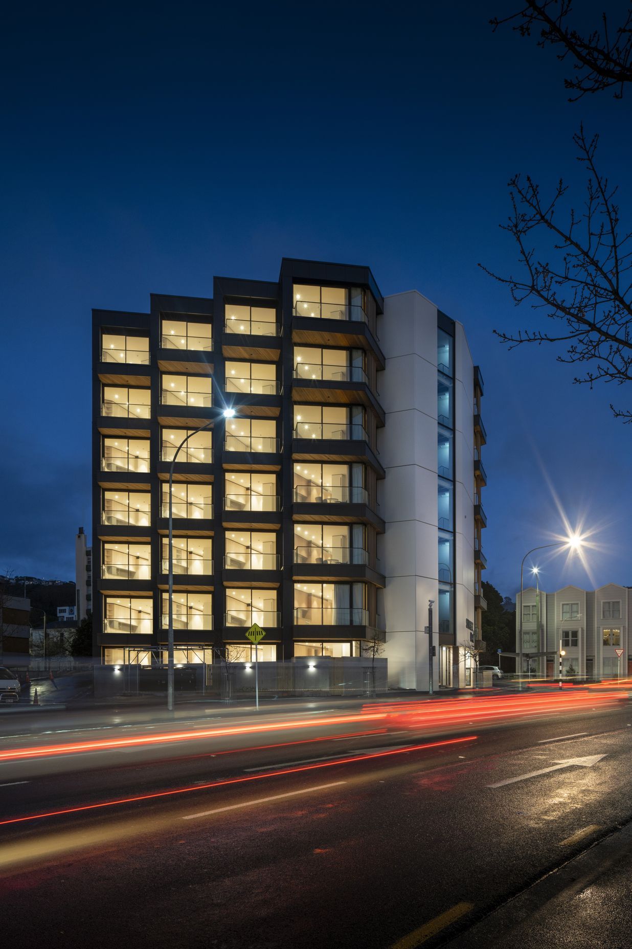 Each apartment features a balcony with views of the city and its maunga.