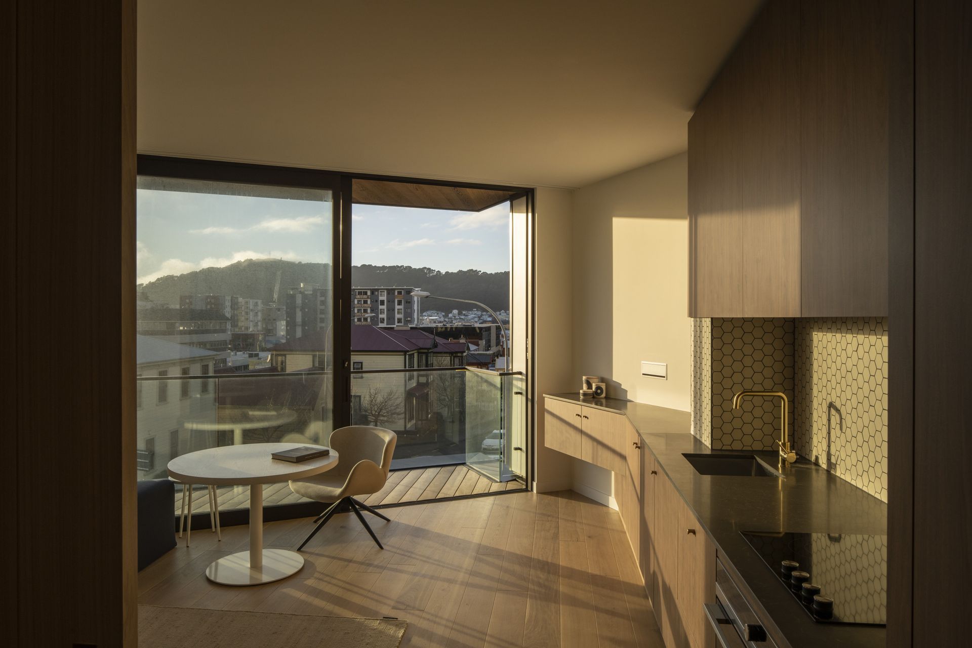 The interior of each apartment features a warm material palette.