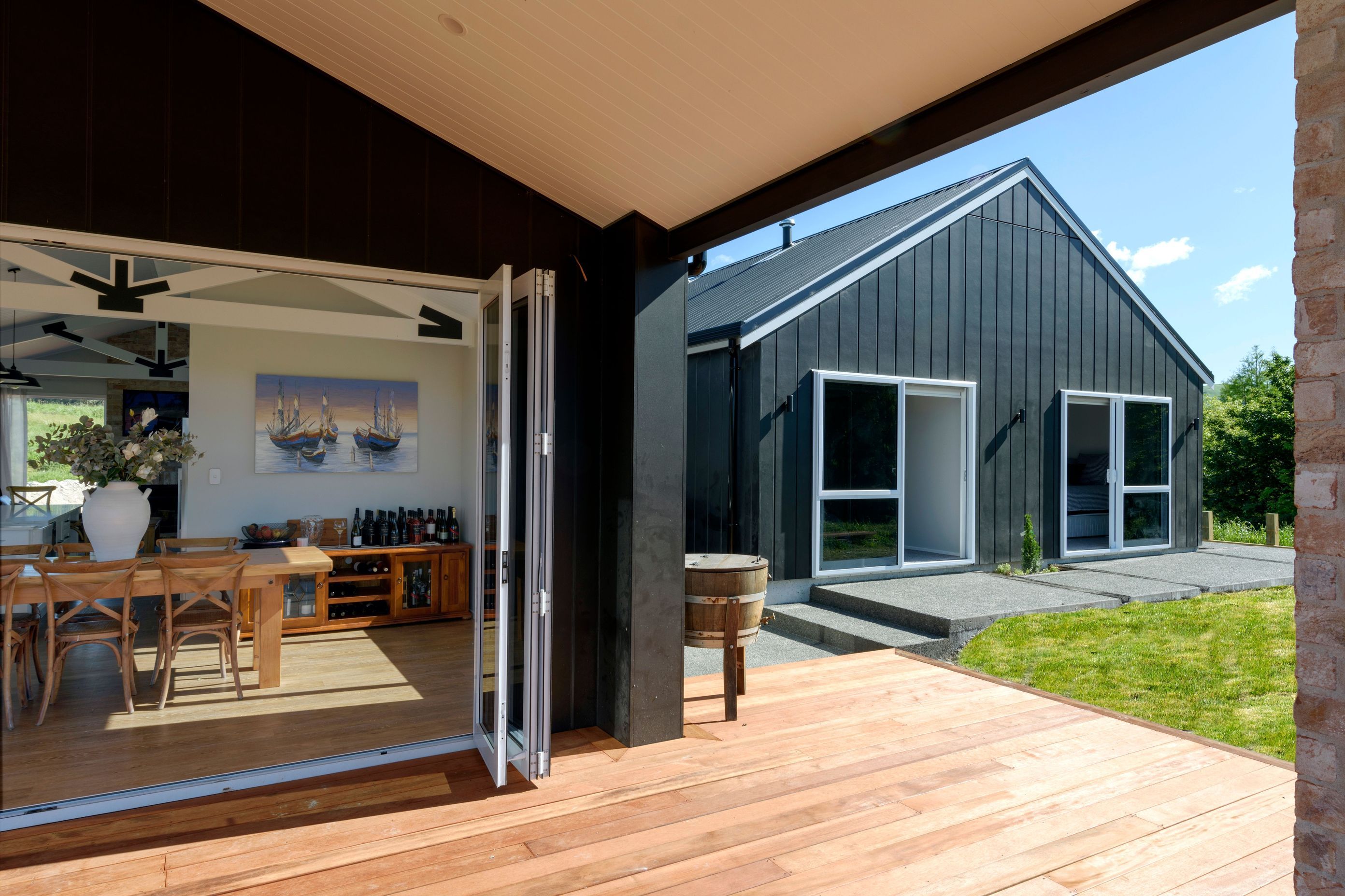 Black Linea Oblique weatherboard cladding and a brick chimney and feature wall to add an industrial feel. Roofing is Colorsteel in Trimrib profile