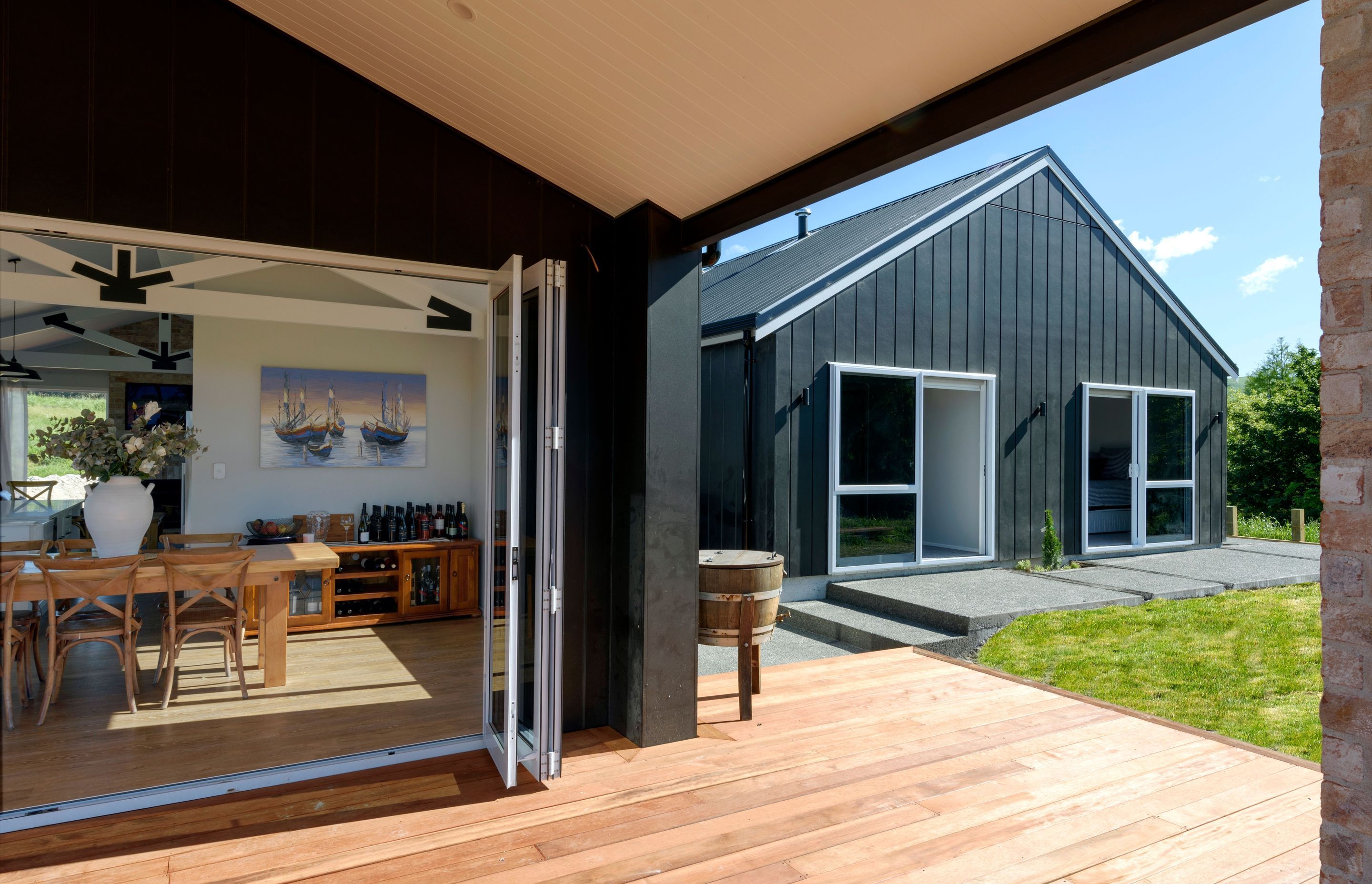 Black Linea Oblique weatherboard cladding and a brick chimney and feature wall to add an industrial feel. Roofing is Colorsteel in Trimrib profile