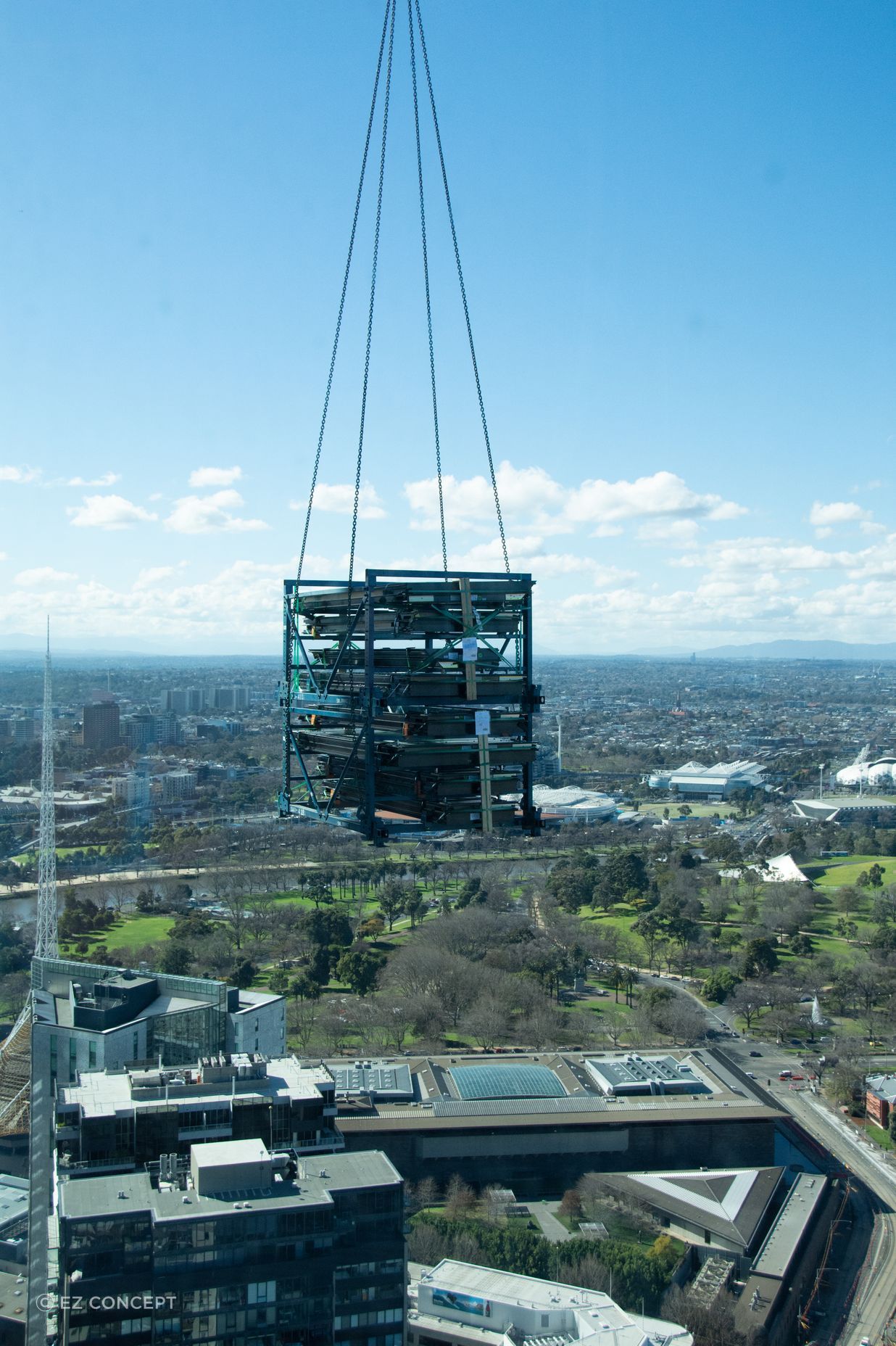 A delivery of steel being lifted to an upper level.