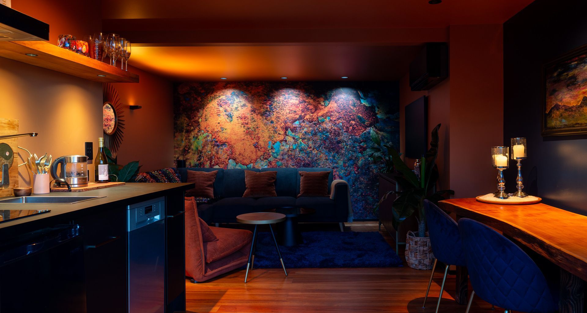 Abstract mural wall, illuminated with a variety of colour temperatures to highlight different colour ranges in the artwork, ranging from 1800K on the left, to 3000K in the centre, and finally 4000k on the right. Product: Switch Lighting ZELA Offset Deep Tilt SLDL251T
