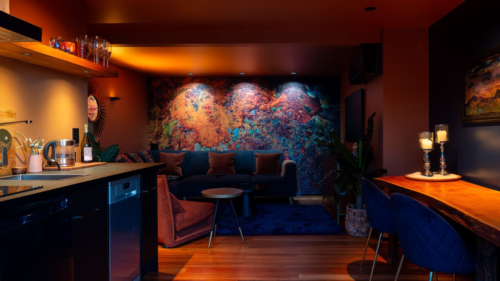 Abstract mural wall, illuminated with a variety of colour temperatures to highlight different colour ranges in the artwork, ranging from 1800K on the left, to 3000K in the centre, and finally 4000k on the right. Product: Switch Lighting ZELA Offset Deep Tilt SLDL251T