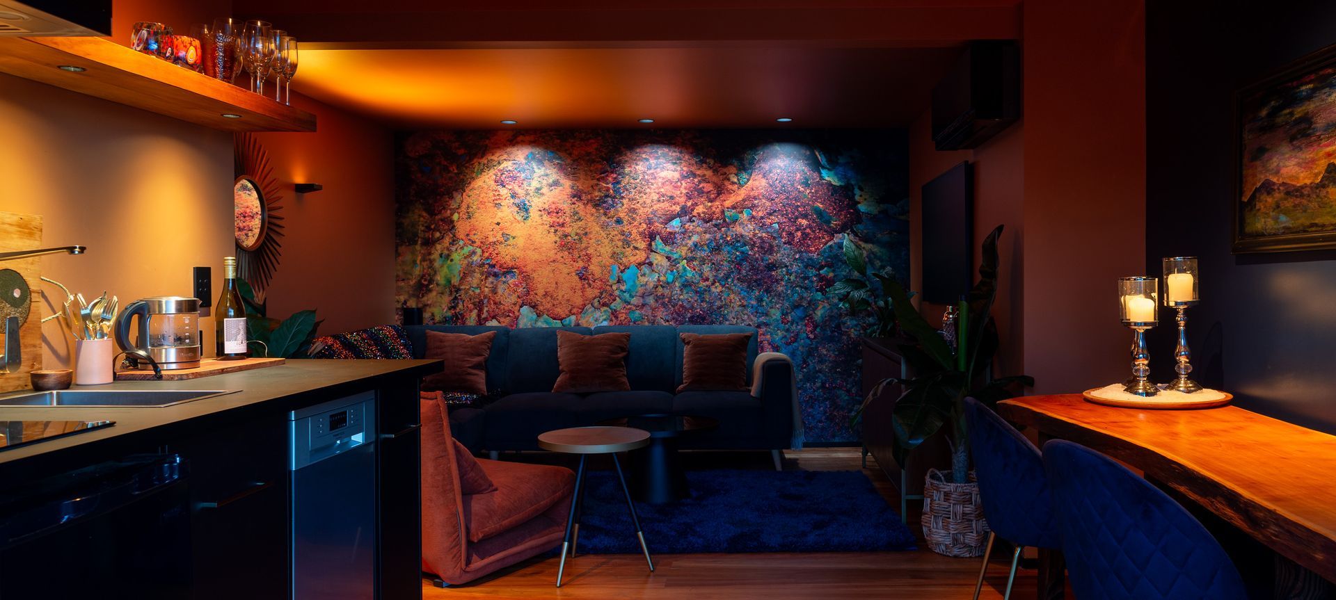Abstract mural wall, illuminated with a variety of colour temperatures to highlight different colour ranges in the artwork, ranging from 1800K on the left, to 3000K in the centre, and finally 4000k on the right. Product: Switch Lighting ZELA Offset Deep Tilt SLDL251T