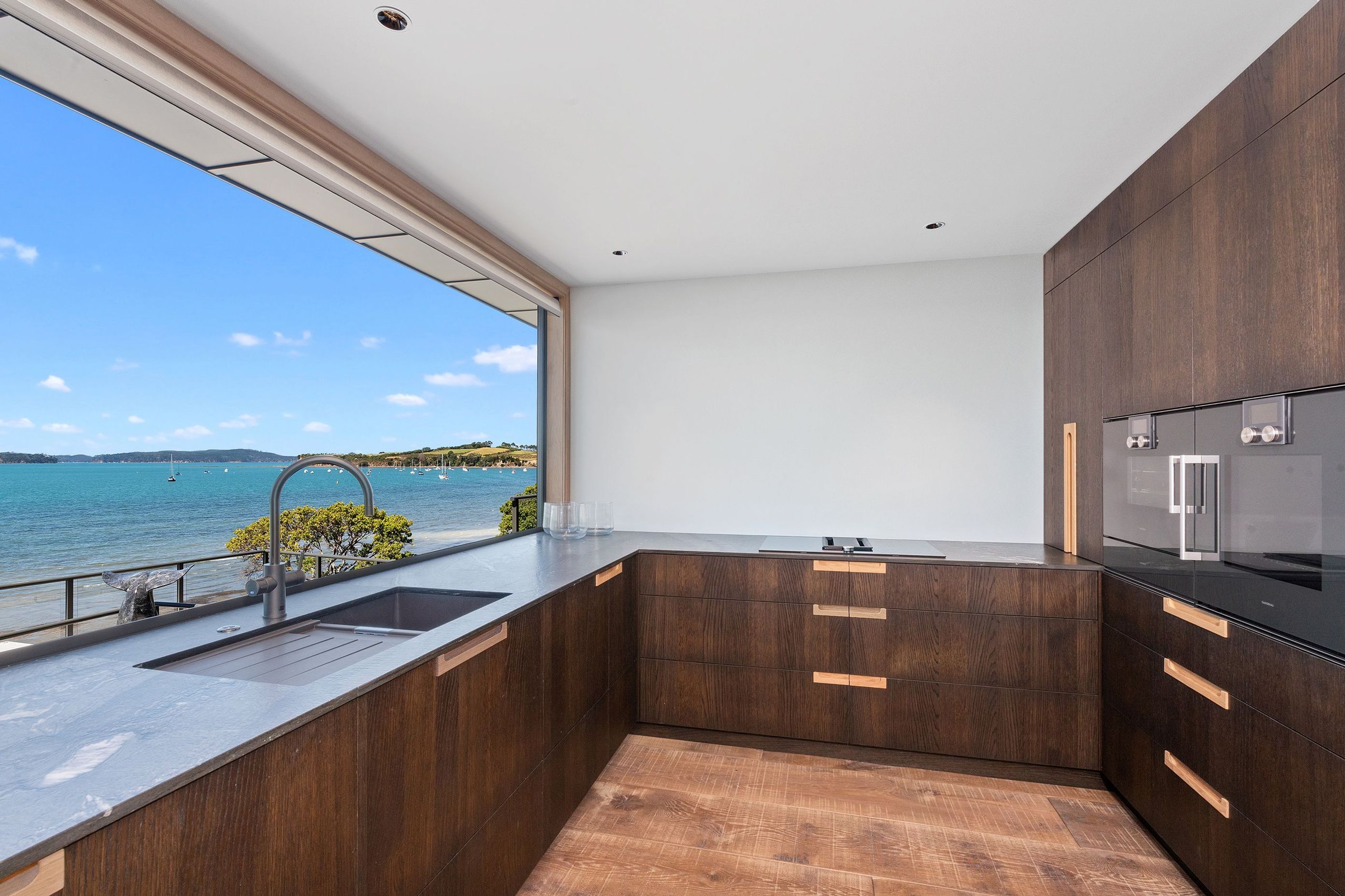 Smoked oak with an oiled finish was chosen for the cabinetry and has been offset with natural oak recessed handles.