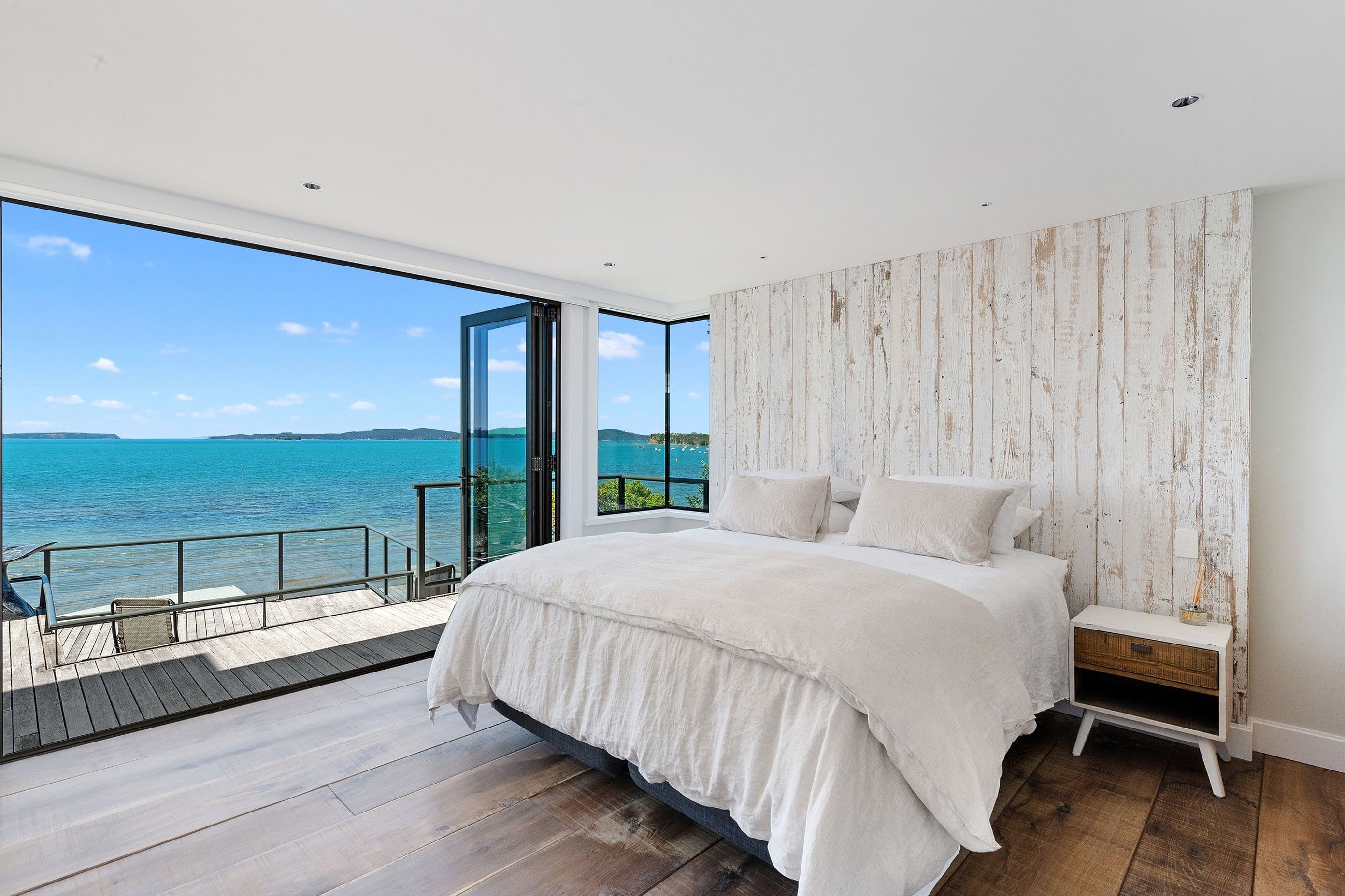 The main bedroom has been pared right back to only contain the bare essentials and given a relaxed feel, enhanced by the bare timber floor and headboard.