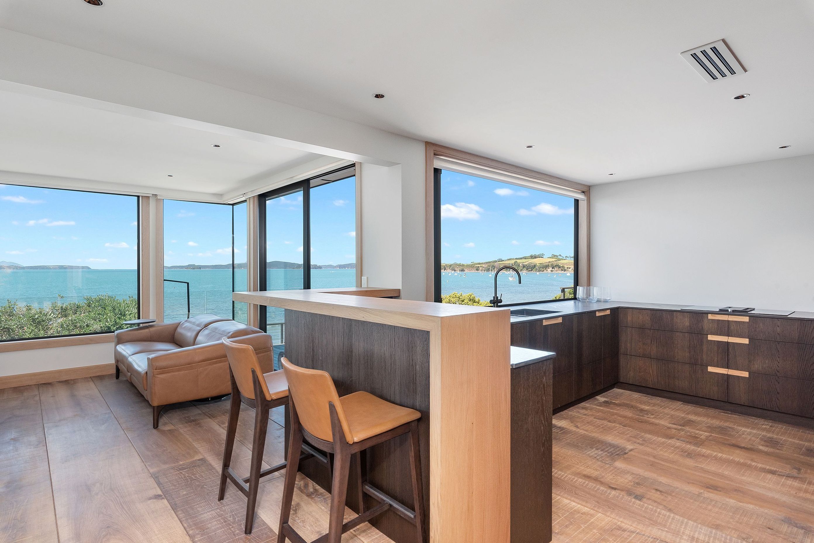 Gunmetal accents, including the window joinery and tapware, were chosen for their ability to recede into the background, leaving the view to come to the fore.