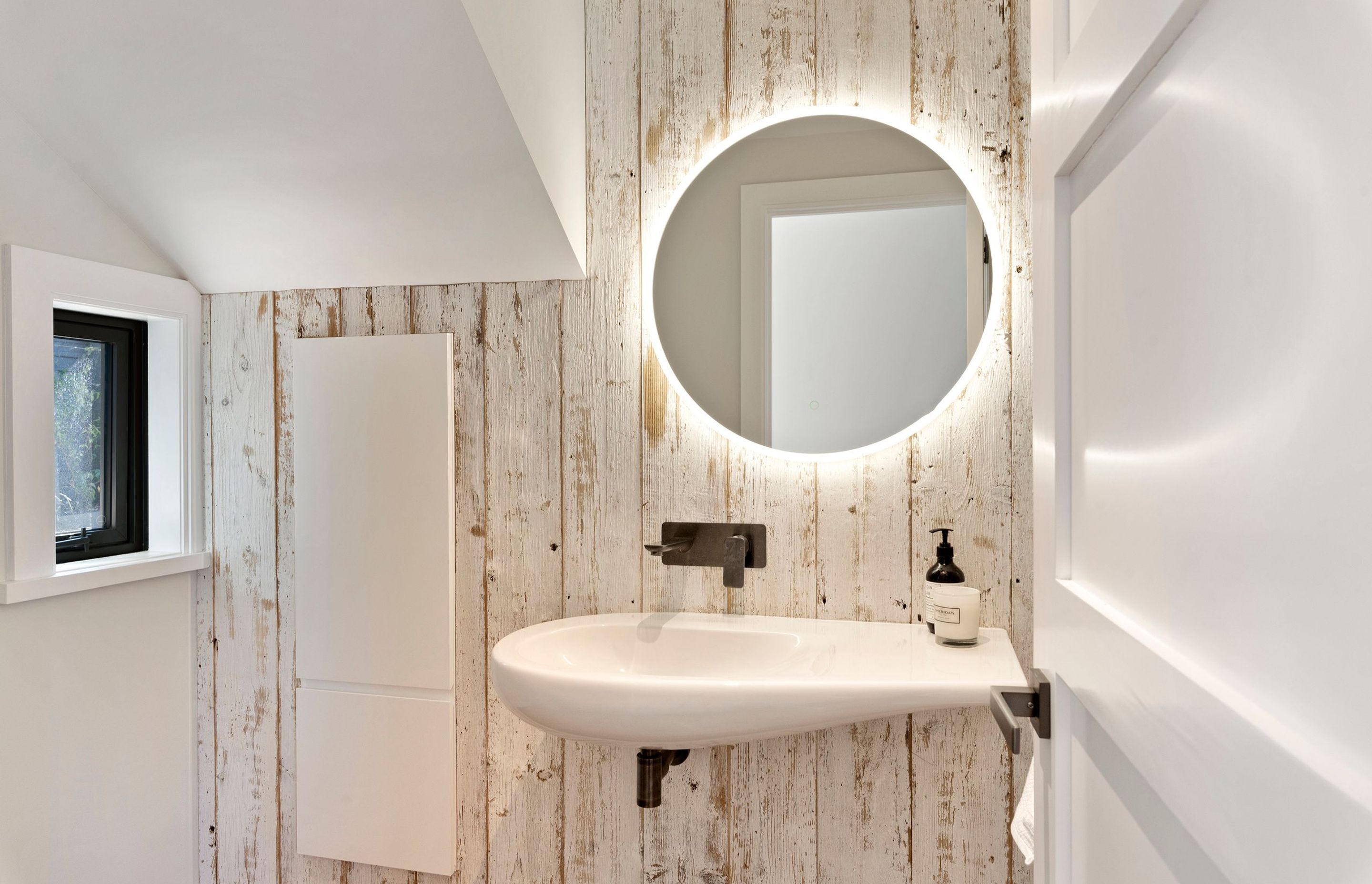 The powder room, too, has the pared back, neutral scheme.