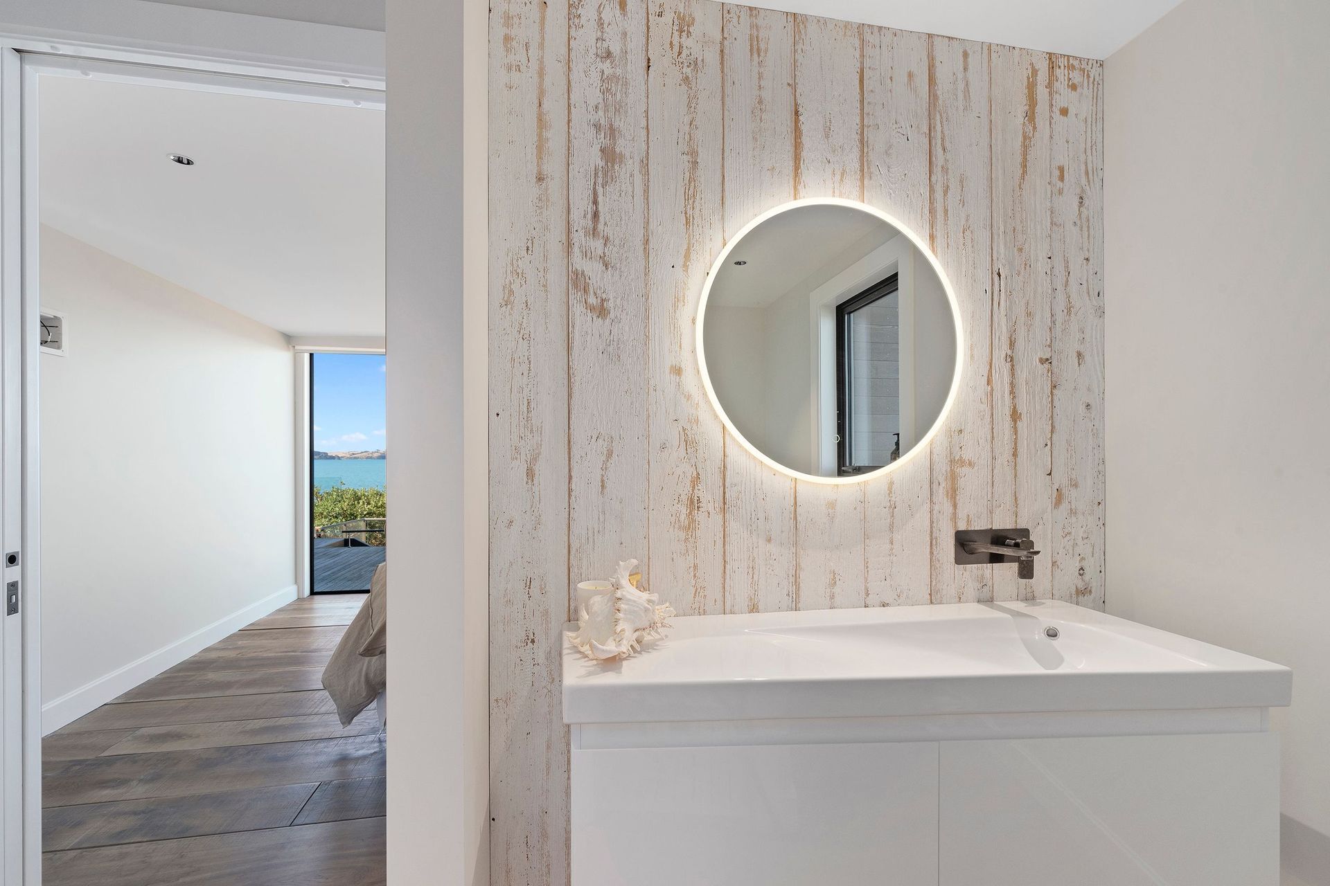 Recycled Canadian barn weatherboards were whitewashed and used as accent pieces in the bathroom and main bedroom.