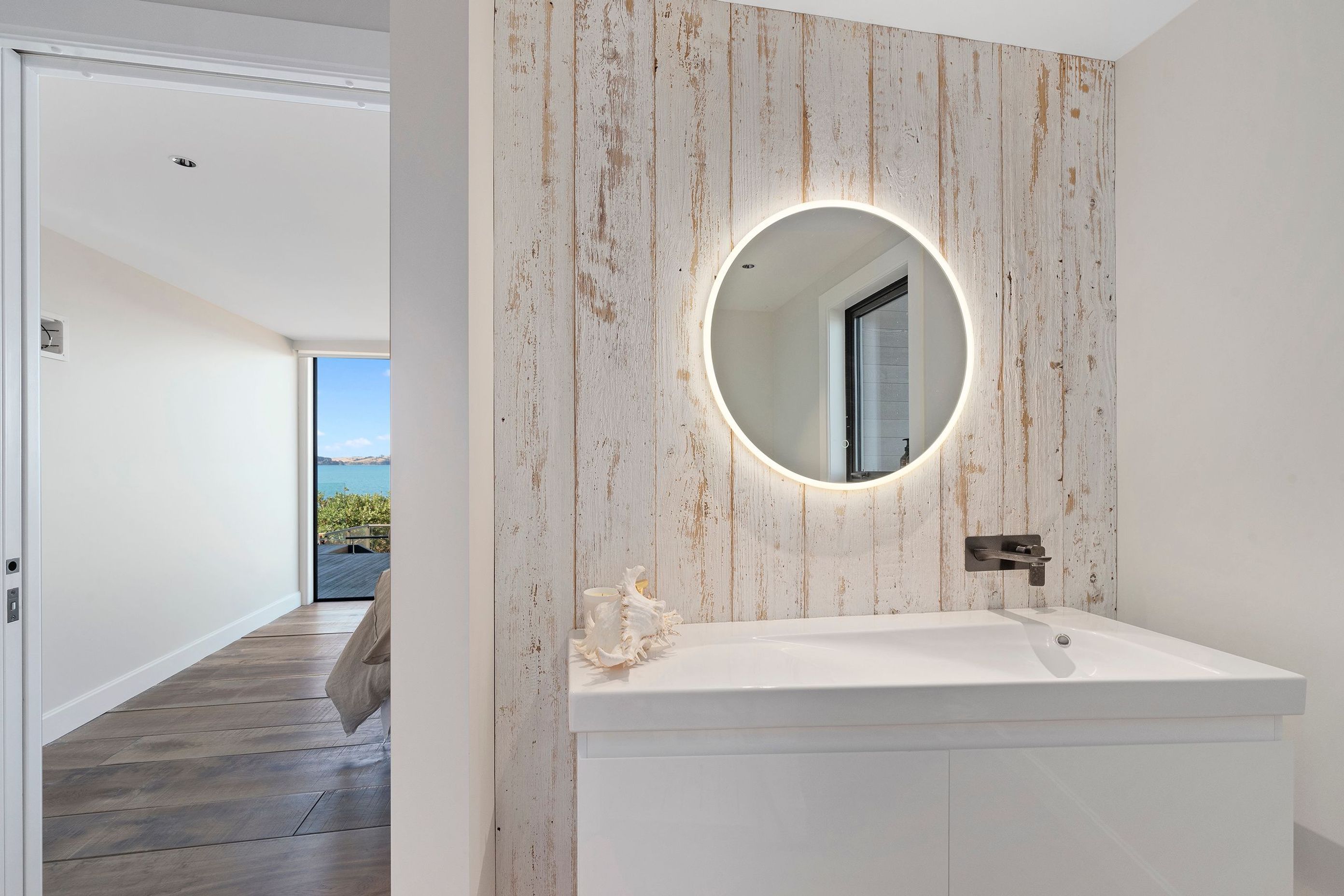 Recycled Canadian barn weatherboards were whitewashed and used as accent pieces in the bathroom and main bedroom.
