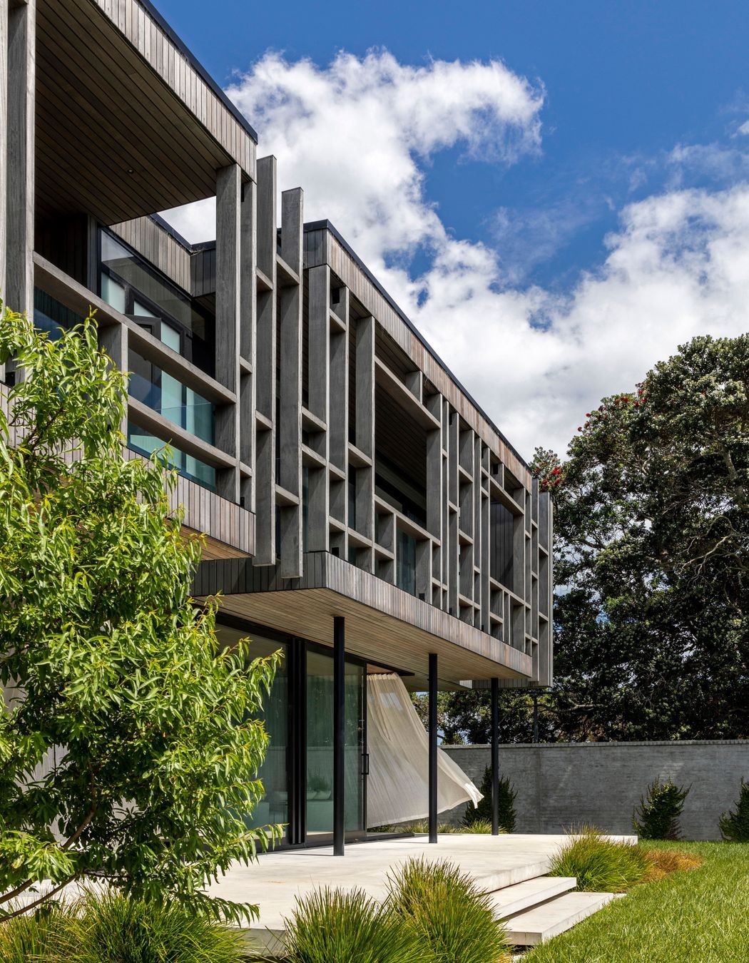 The timber structure of the upper level cantilevers over the lower level.