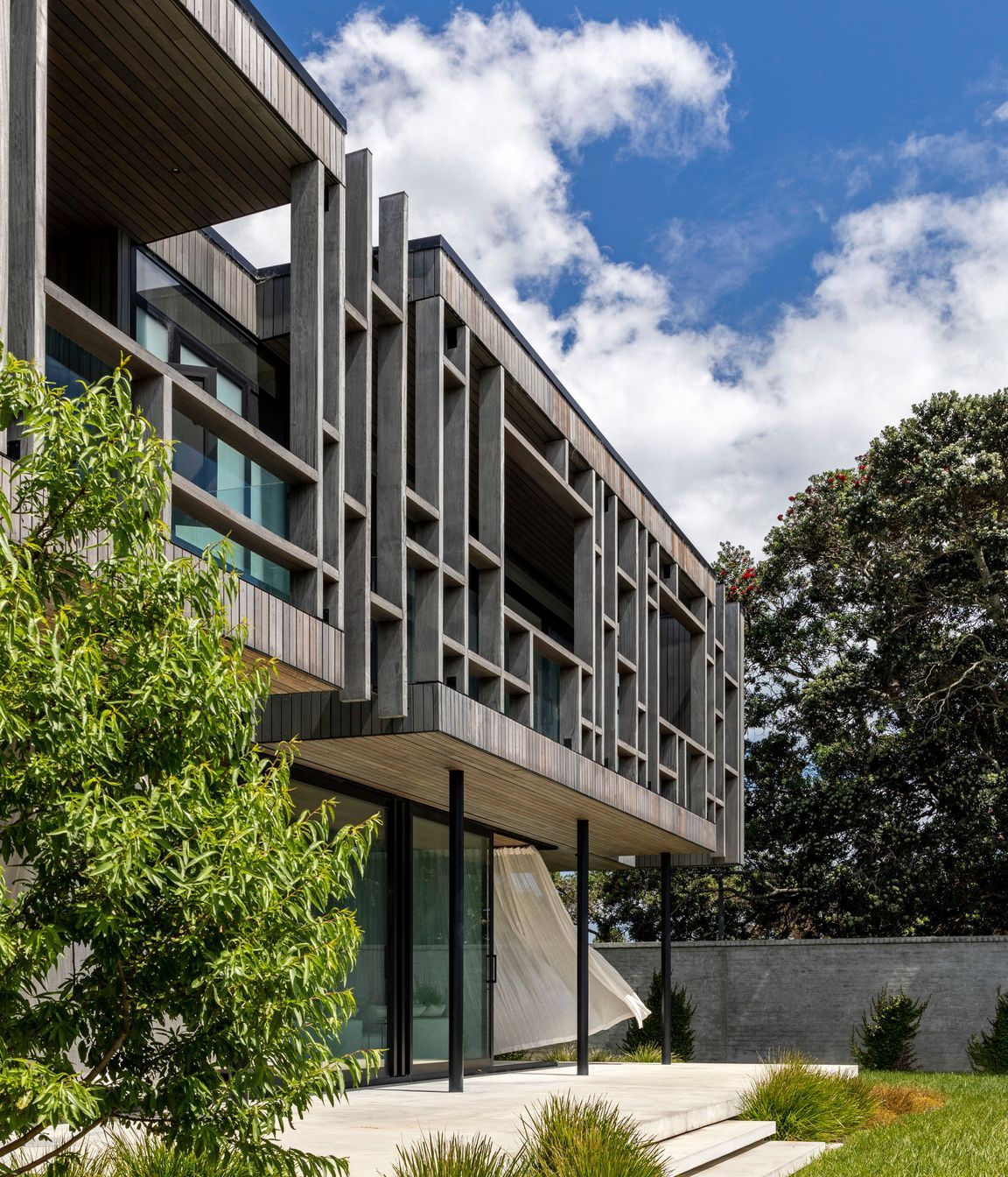 The timber structure of the upper level cantilevers over the lower level.