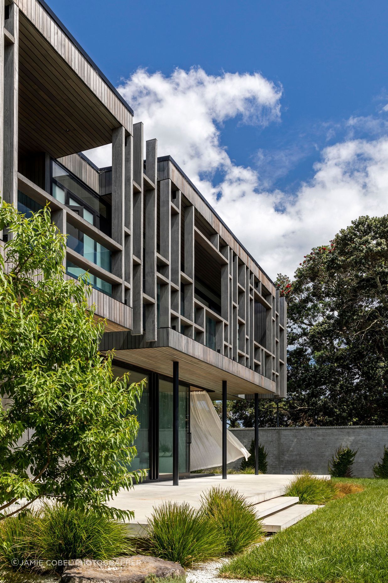 The timber structure of the upper level cantilevers over the lower level.