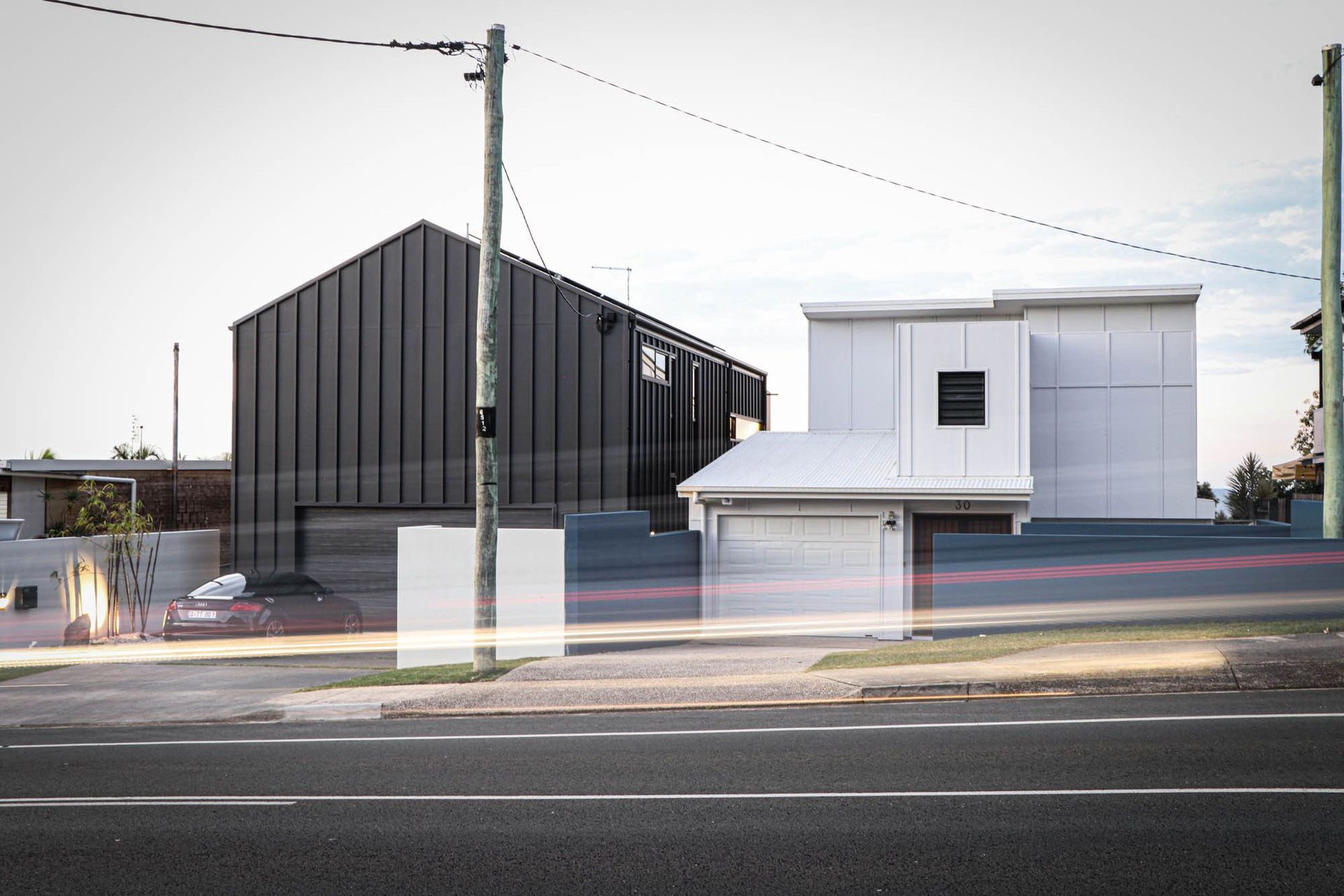 Anderson Residence - Exterior. The dark gabled home beside its white neighbour on the street.